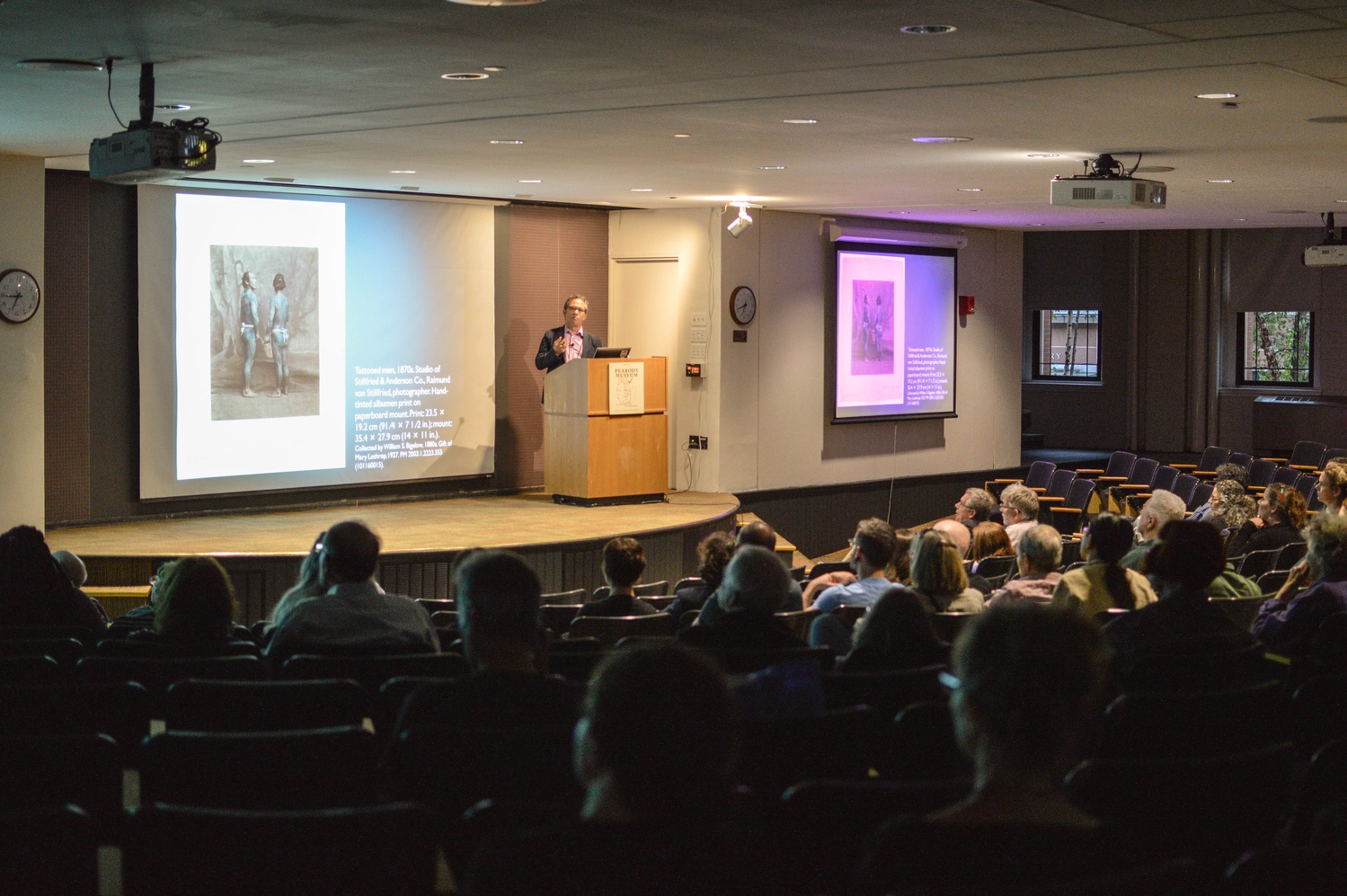 David R. Odo, director of student programs at the Harvard Art Museums, speaks to a crowd on Thursday night about the legacy of early Japanese photographs as both art and works of ethnography. During the discussion, Odo also questioned whether photos in the digital age would have the same gravitas as historical photos. 
