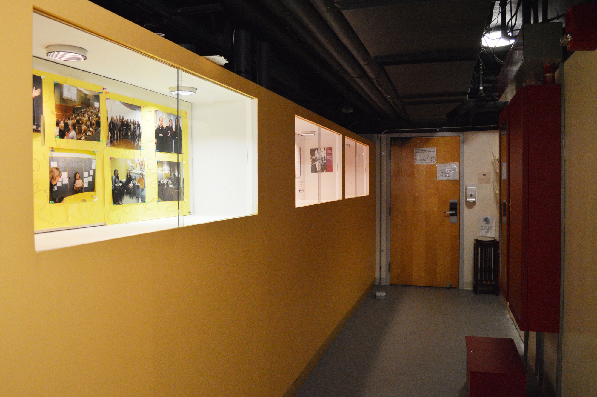 A well-lit wall displaying photos from various Women’s Center events leads the way to the Women’s Center door at the basement of Canaday B. The Women’s Center is slated to re-launch the Women’s Cabinet, an organization of the College’s women-focused group leaders that will discuss women and gender issues.