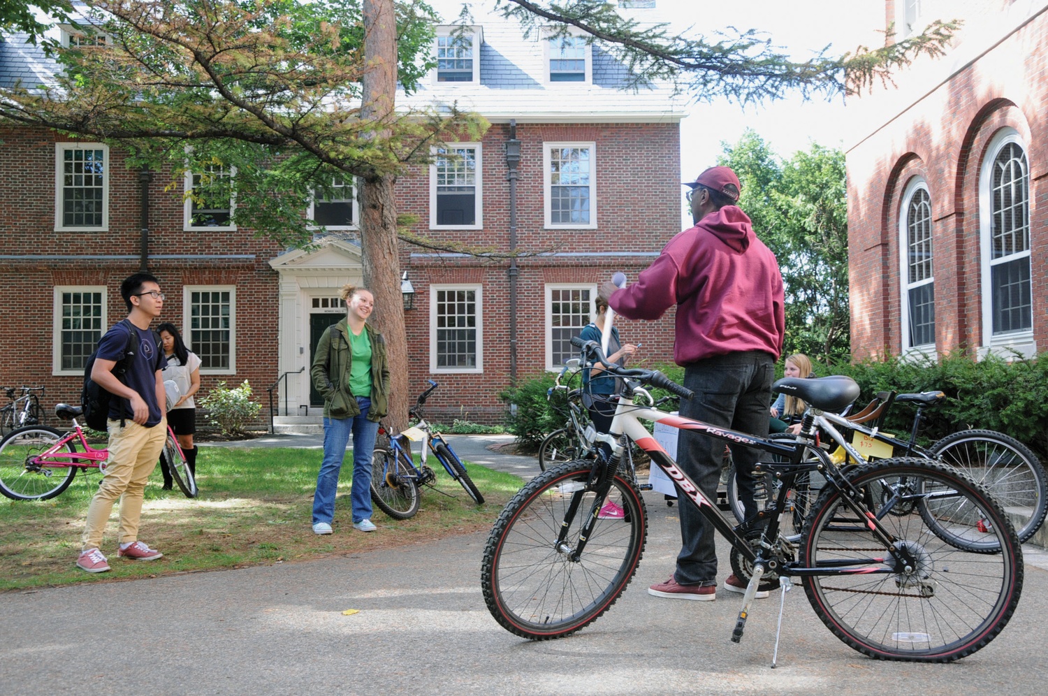 A PBHA volunteer asks for bids on a bike at the PBHA annual bike sale. The auction typically raises around $3,000 to fund PBHA’s programs each year.