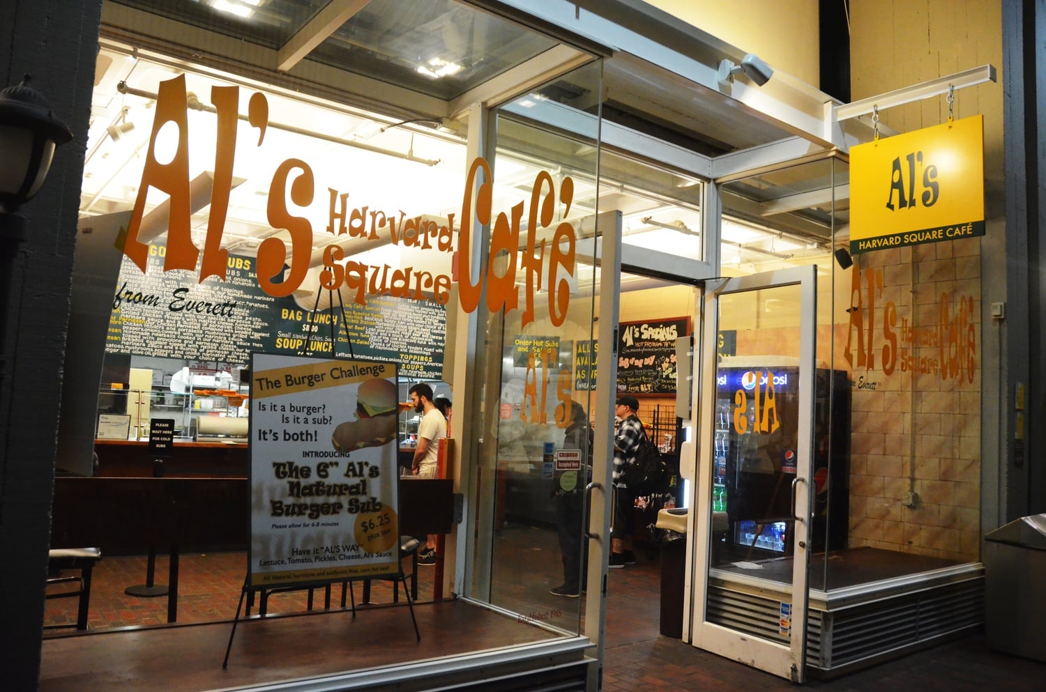 Customers line up for made-to-order sandwiches at Al’s Sandwich Shop on Monday evening.