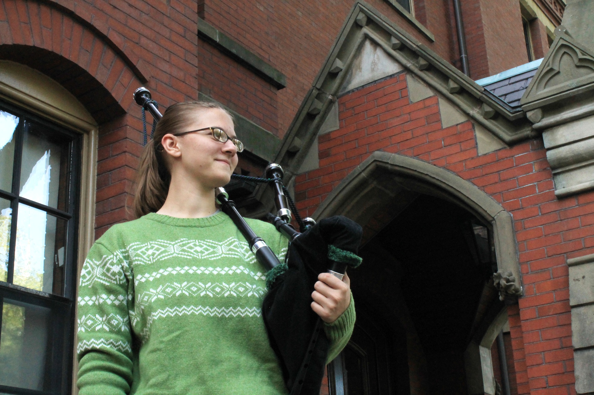 Alaina M. Richert, a freshman from Indiana, poses outside Matthews Hall with her pipes. Richert practices regularly in the freshman music rooms located in the basement of Matthews.