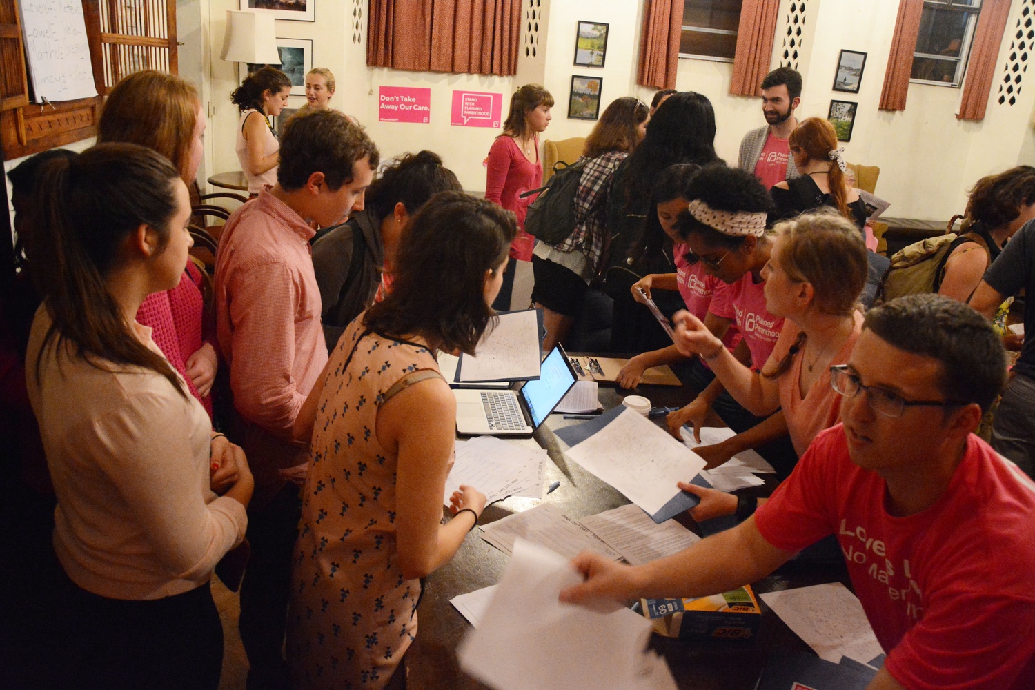 Participants check-in for 'Pink Out Day for Planned Parenthood' in the Adams Junior Common Room.  The Harvard College Democrats and Planned Parenthood Advocacy Fund of Massachusetts organized the event where students donned pink and canvassed in Harvard Square in support of the organization Tuesday night.