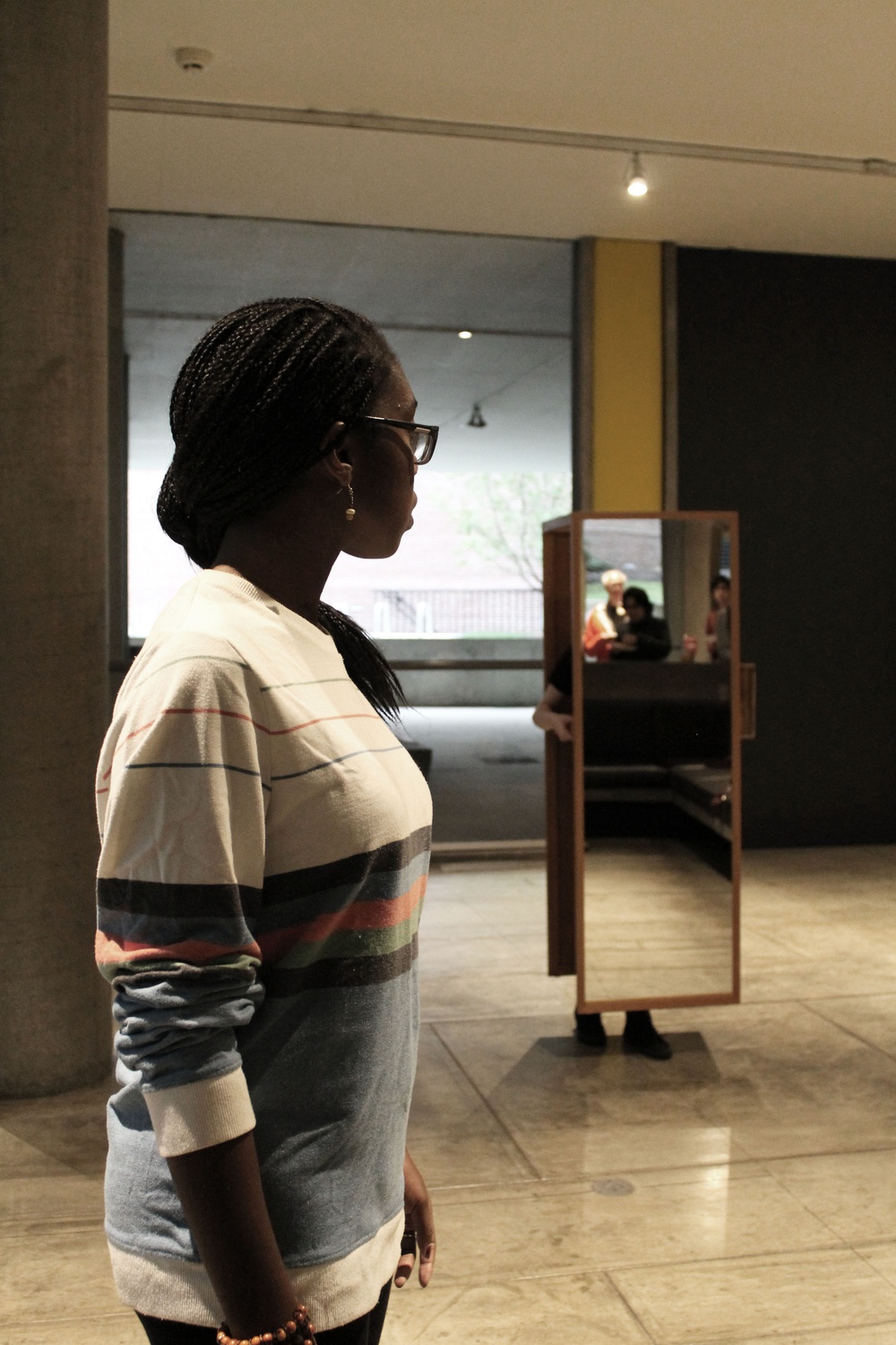 Ivie Tokunboh ’16 guides fellow dancer Elizabeth Leary in an exhibit, entitled “Two Walking Mirrors for the Carpenter Center,” which will be open to the public until October 25. 