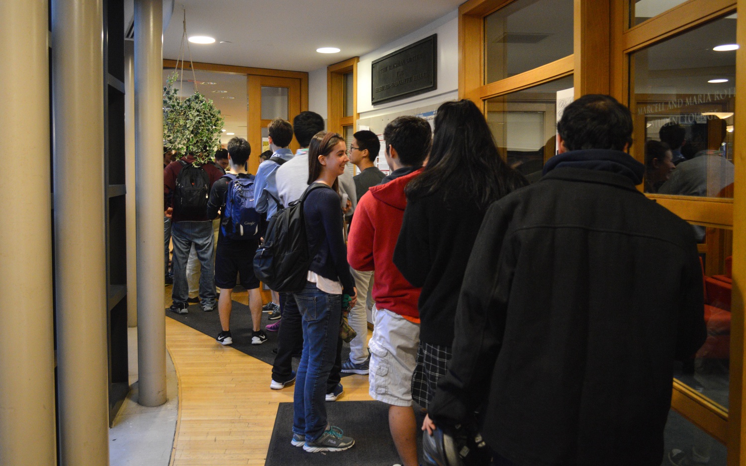 A line of students form in the hallway to the Sukkah of the Harvard Hillel. Hillel saw an increase in dining hall traffic upon serving sushi on Thursday evening. 
