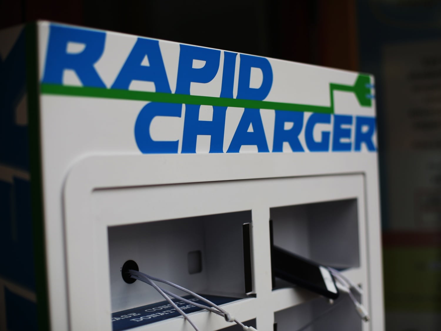 A new charging station, located at 6 JFK Street, solicits donations for Y2Y Harvard Square, a student-run homeless shelter that is scheduled to open this fall.