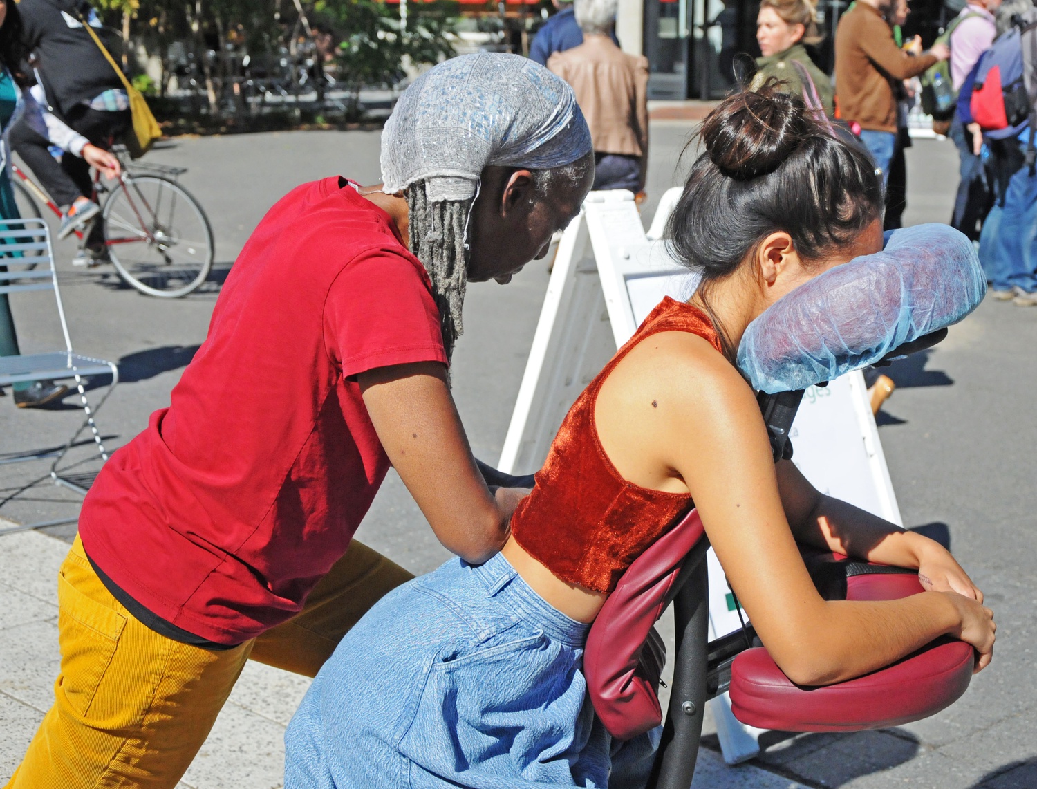 Sharon Woodbine gives Terilyn S. Chen ‘16 a free chair massage at the Science Center Plaza on Wednesday afternoon. This event was sponsored by Harvard University Health Services Center for Wellness.
