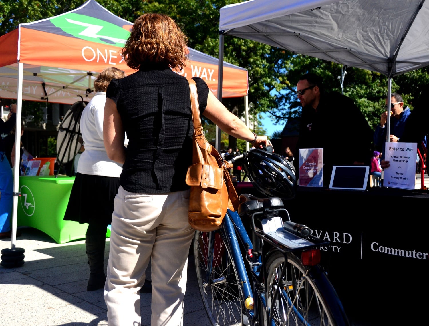 Cyclists, fitness enthusiasts, and doughnut-lovers alike stop by the Green Transportation Celebration in the Science Center Plaza to learn more about traveling “green” at Harvard on Thursday. 