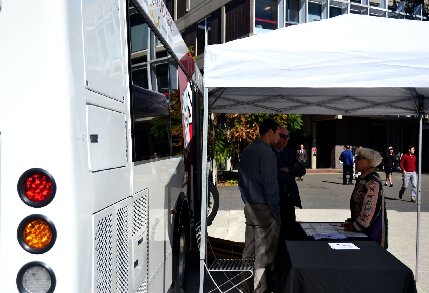 On Thursday, members of the Harvard community stop by the Science Center Plaza to learn more about green transportation initiatives on campus. Here, an eco-friendly bus was a topic of discussion. 