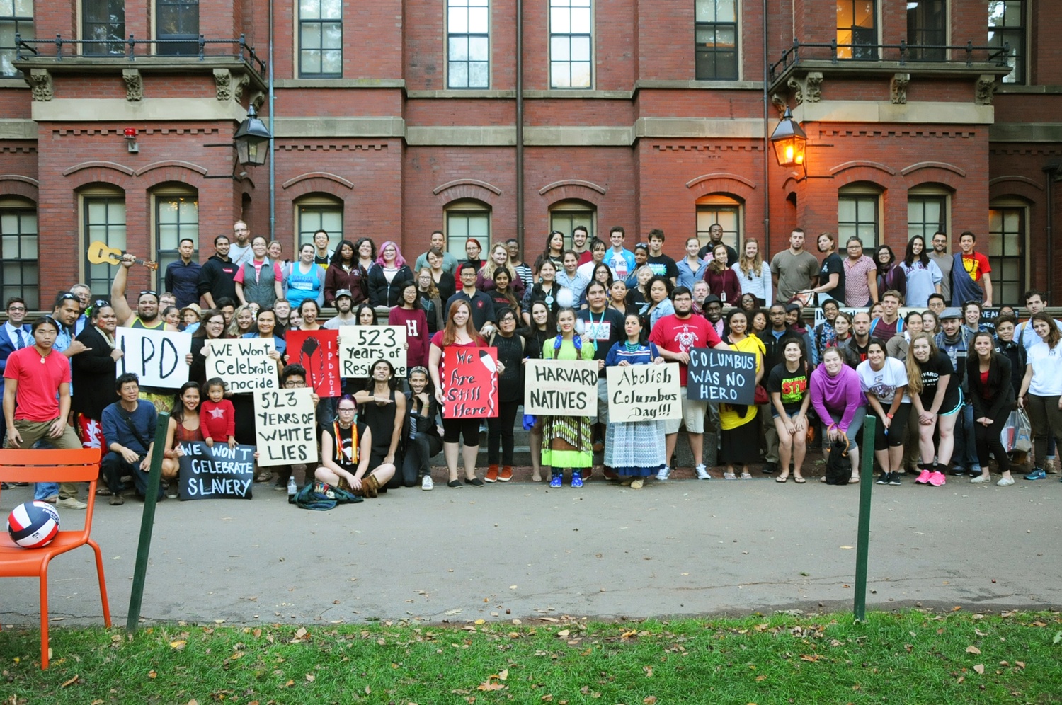 Performers and audience members at the Indigenous Peoples’ Day celebration pose for a photo in Harvard Yard on Monday.