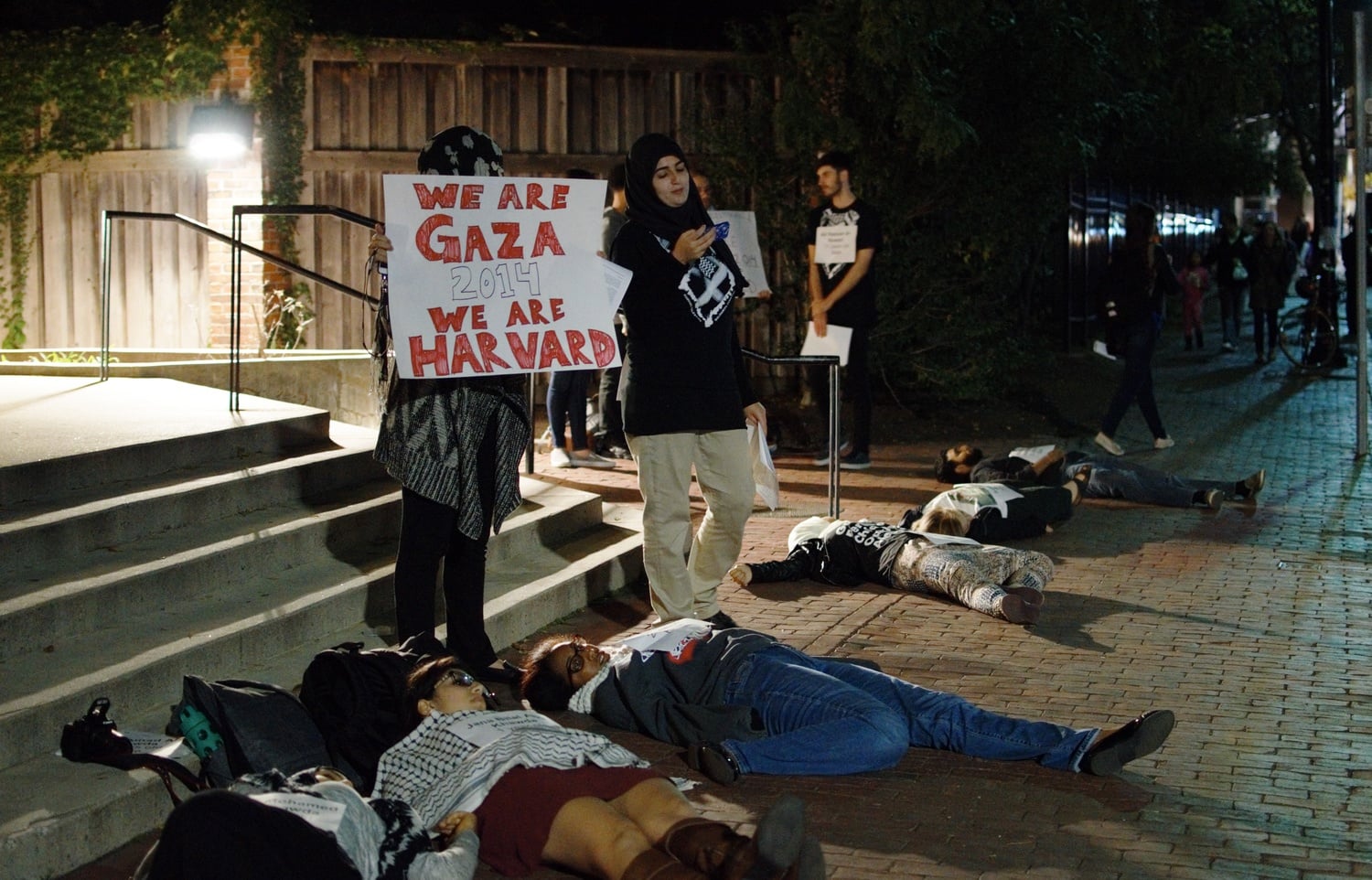 Co-president of the Palestine Solidarity Committee Fatima Bishtawi ’17 stands outside the Hillel to protest Operation Protective Edge, an Israeli military operation launched in 2014. Other members of the Palestine Solidarity Committee lay on the ground around her. 