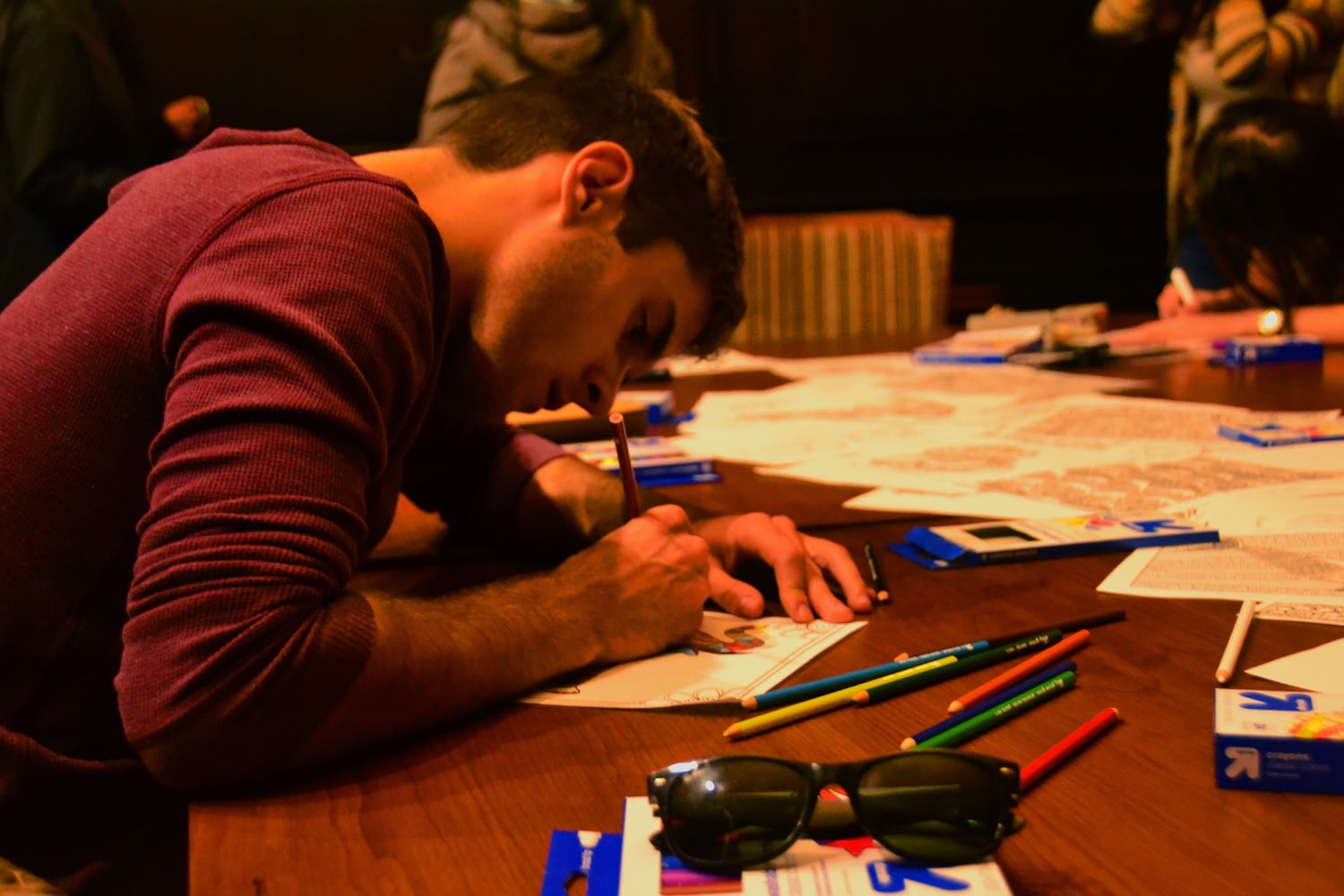 Daniel Banks ’17 colors an intricately designed elephant at the Relaxation Study Break hosted by the Asian American and Pacific Islanders Community as part of Mental Health Awareness Week in Dunster House. With elephant and Pokemon coloring sheets, family board games, healthy snacks from CVS, and Christmas music, attendees were encouraged to relax and destress from midterms. 
