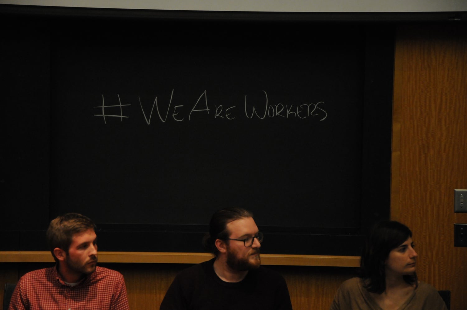 Graduate students Andrew B. Donnelly, John M. Nicoludis, and Joan E. Chaker turn their attention to a fellow panelist. The Graduate Student Union hosted Harvard and community speakers as part of the We Are Workers: National Graduate Worker Day of Action.