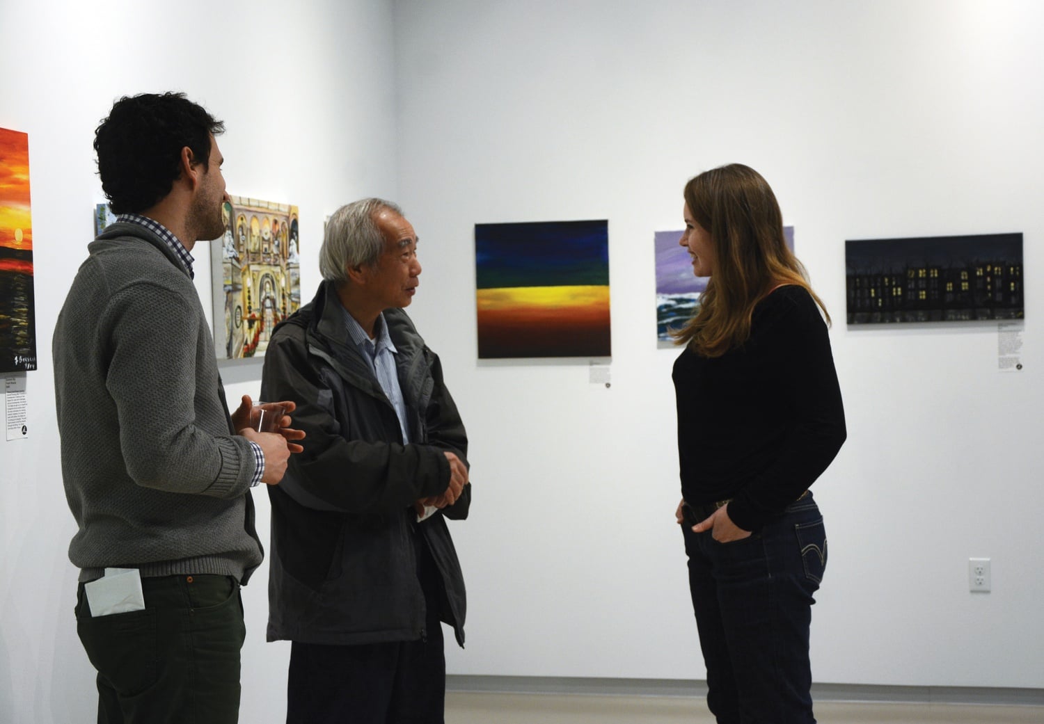 Liz J. Powers ’10, founder of ArtLifting, talks to visitors during the opening of “Life-Changing Art” at the Harvard Ed Portal on Saturday evening. ArtLifting, which is partnering with the Ed Portal to open the new exhibit, is an organization that seeks to provide a way of earning an income to homeless or disabled artists across the country.