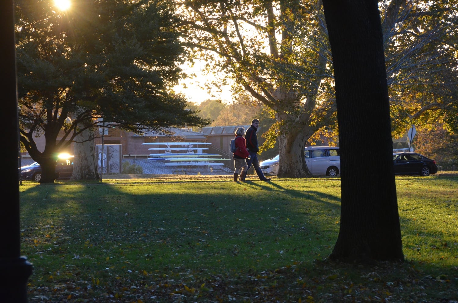 People walk through John F. Kennedy Park by the Charles River on Monday afternoon.