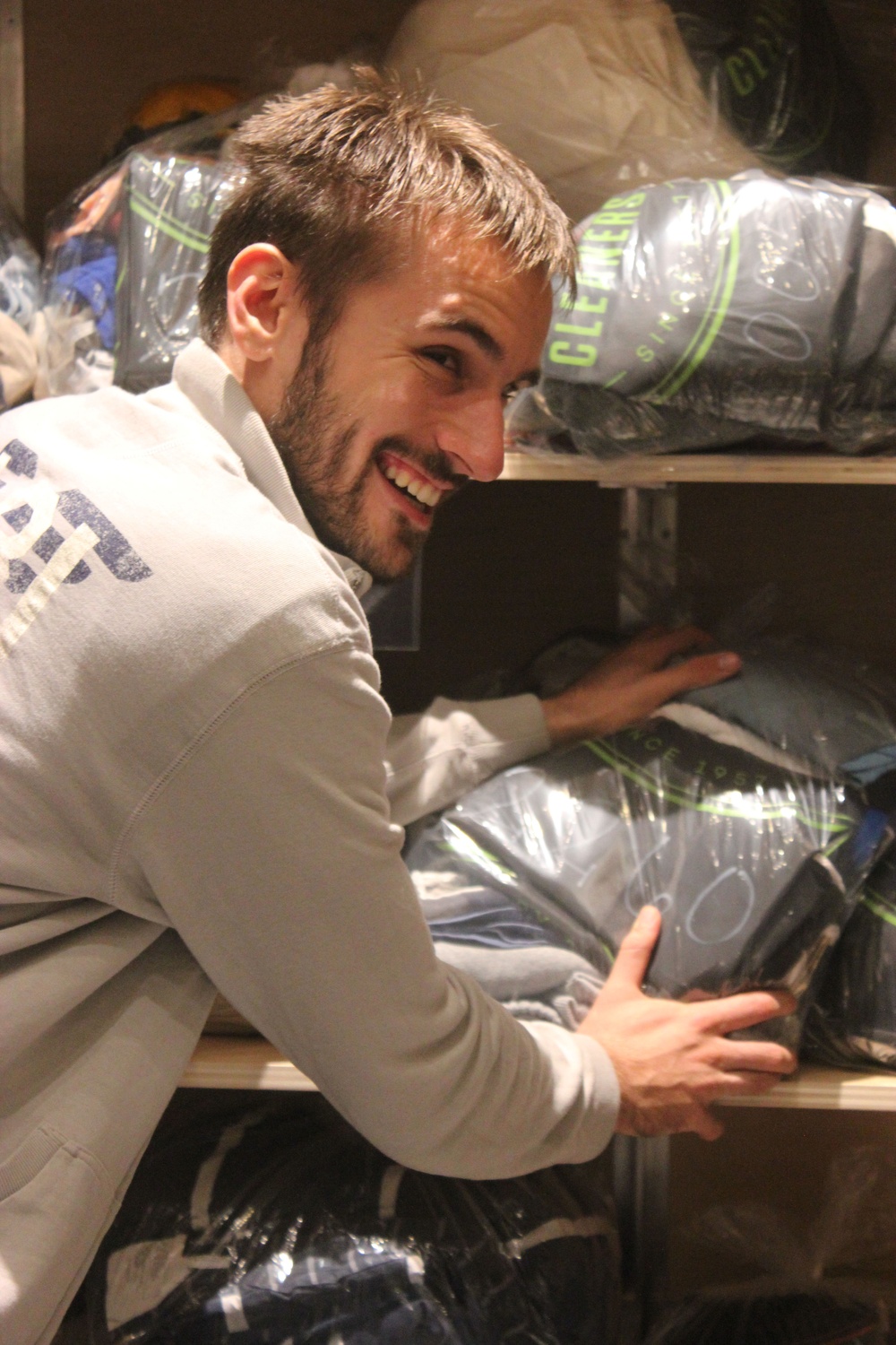Luka Kordic loads bags of laundry off the shelf in preparation for a delivery run to the Yard dorms. 