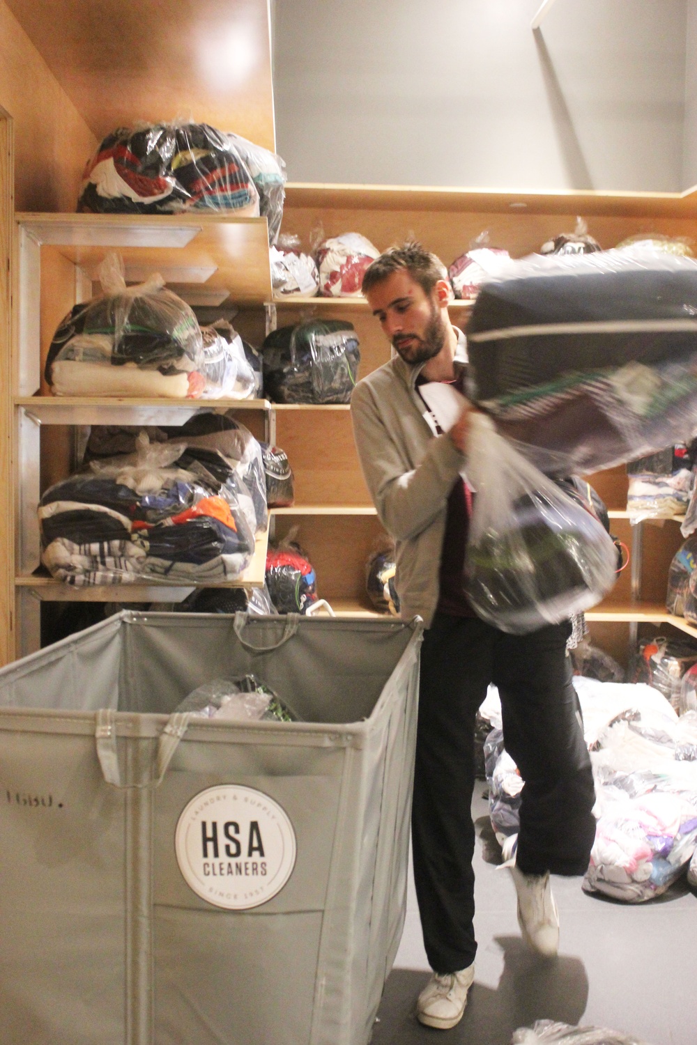 Luka Kordic loads bags of laundry into a cart in preparation for delivery. Kordic likes delivering during the winter the best because he “can handle the cold” and the job pays well.