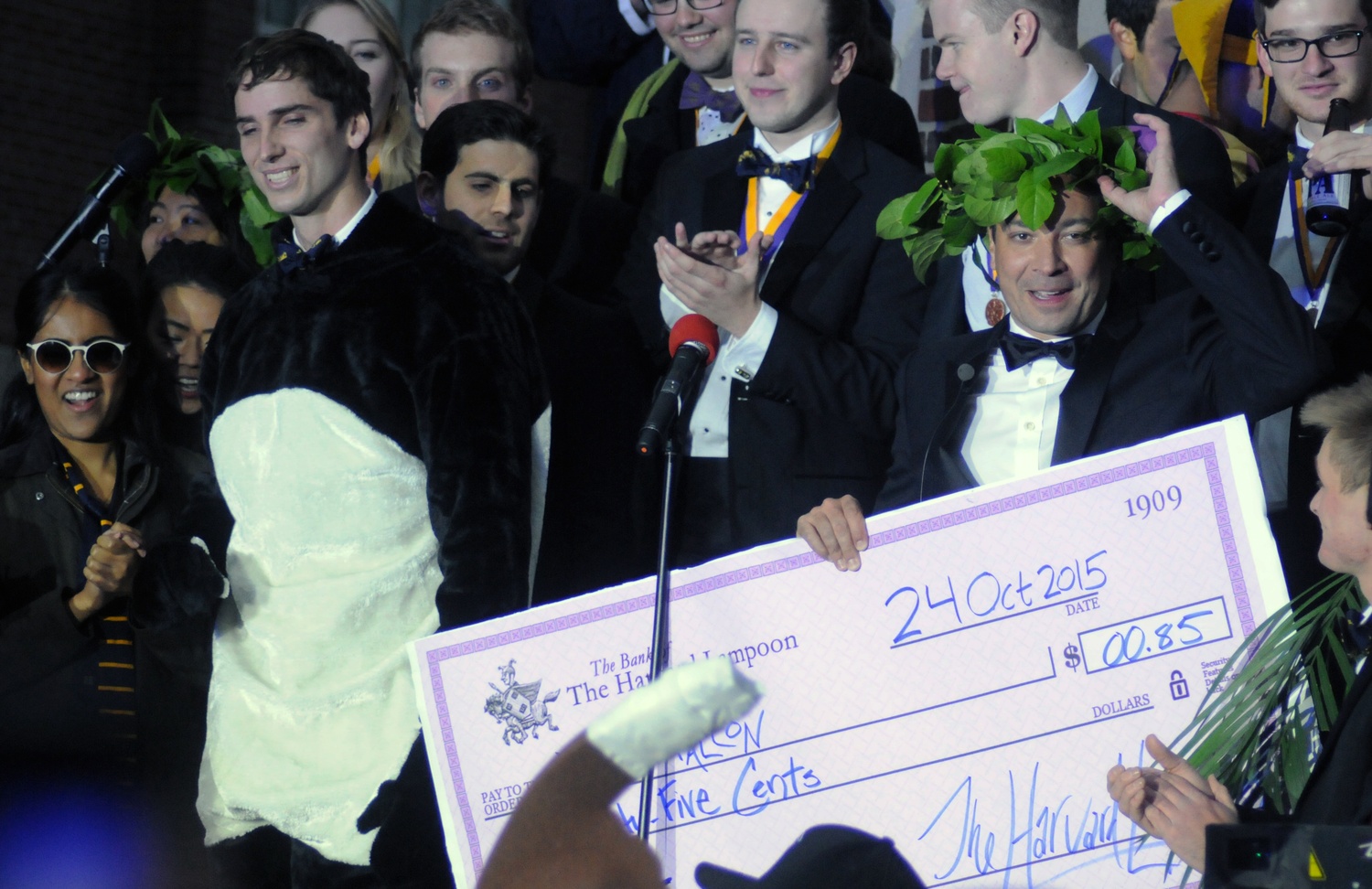 Jimmy Fallon, host of “The Tonight Show,” accepts a check for $0.85 from the Harvard Lampoon on Saturday afternoon.