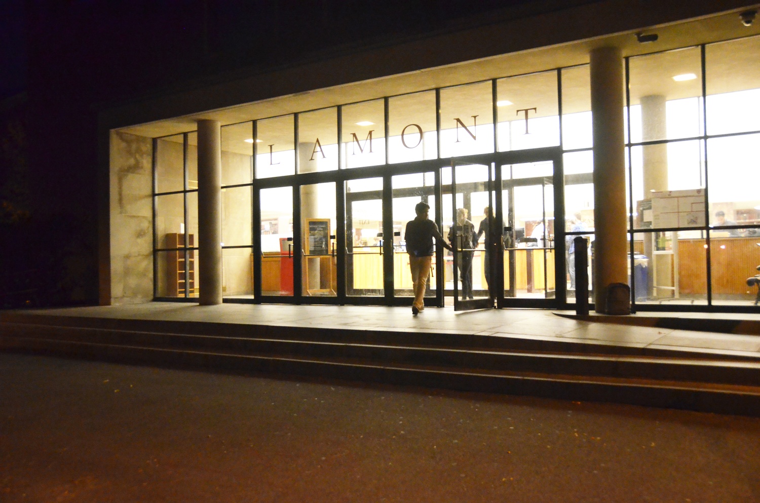 Students exit Lamont Library on Monday evening.