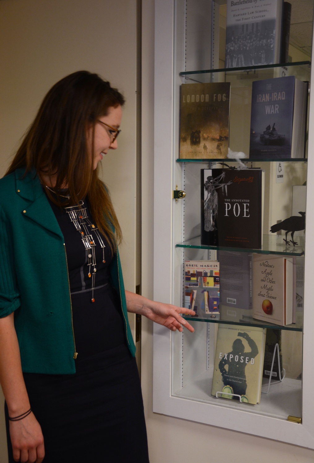 Amanda Peery '14 showcases a few of the books she has work on during her time at Harvard University Press. Peery concentrated in English during her time at Harvard.