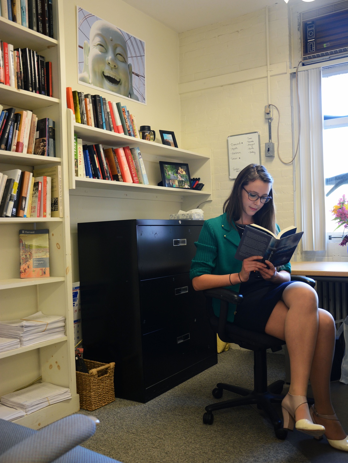 Amanda Peery '14, an English concentrator, opens a book to read in her office at Harvard University Press. Peery said than a career in publishing “doesn’t start in college at all in the sense that you will have a job lined up when you graduate from college... There’s no straight path like there is for finance or consulting.”