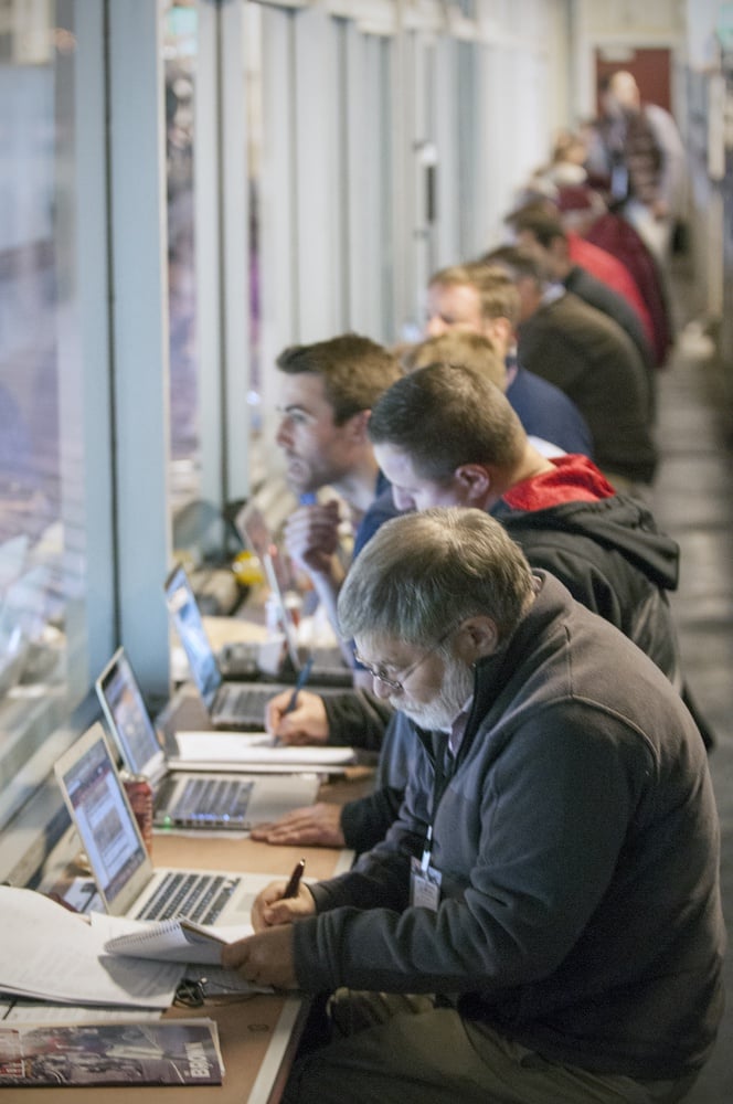 Dick Friedman, bottom, watches the Harvard-Brown game from the press box alongside other reporters. Friedman, the head football writer for Harvard Magazine, was one of nearly 200 credentialed media members on hand for the game. 