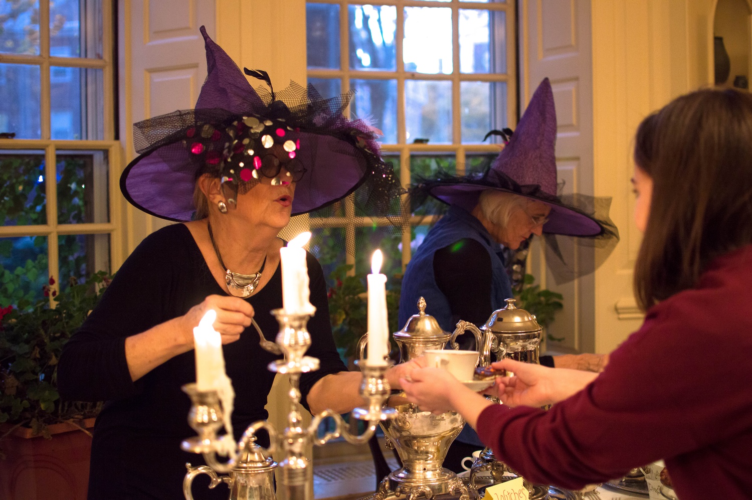 During a Halloween-themed Lowell Tea, Housemasters Diana L. Eck and Dorothy A. Austin serve tea to visiting students. The housemasters host Lowell Tea, which is open to all undergraduates, every week.