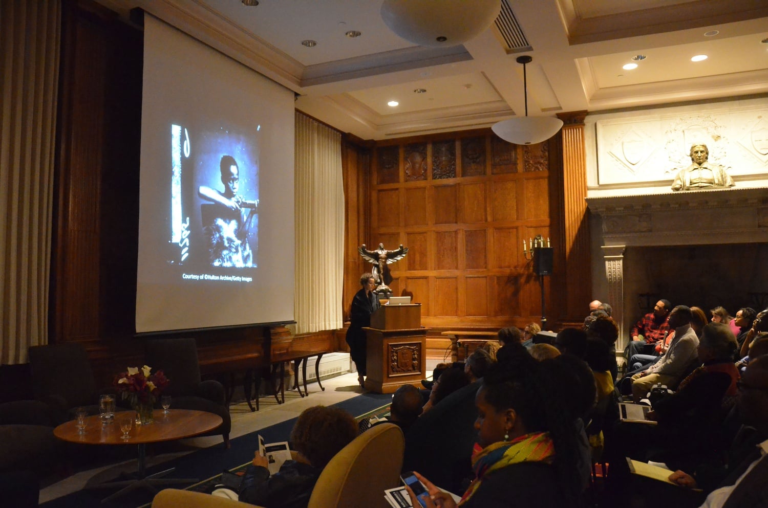 Renée Mussai, a curator and scholar on the African diaspora and Black British photographic history, speaks about photograph “Zulu Boy” as part of the Black Chronicles II Symposium in the Hutchins Center on Monday evening.