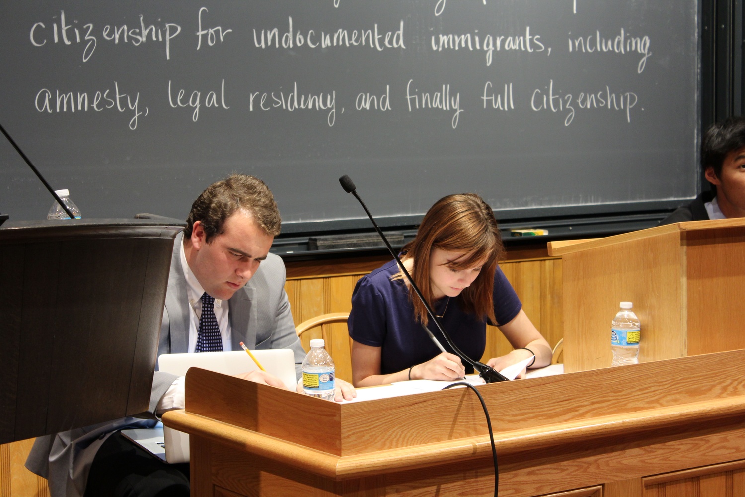 Harvard Republican Club members Cameron K. Khansarinia ’18 and former Crimson business associate Gwendolyn R. Thomas ’17 prepare for an immigration debate between the college Republican and Democrat student groups on Wednesday night. Debaters responded to a resolution on an expedited path to citizenship for undocumented immigrants.
