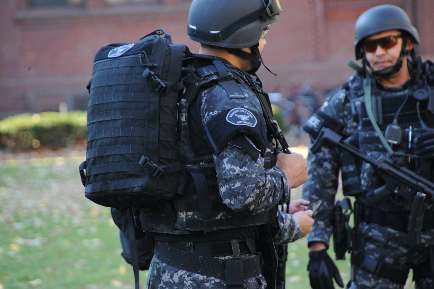 Members of the Cambridge Police Special Response Team (SRT) converge outside of Sever Hall Monday afternoon. The building was one of many evacuated during the the bomb threat.
