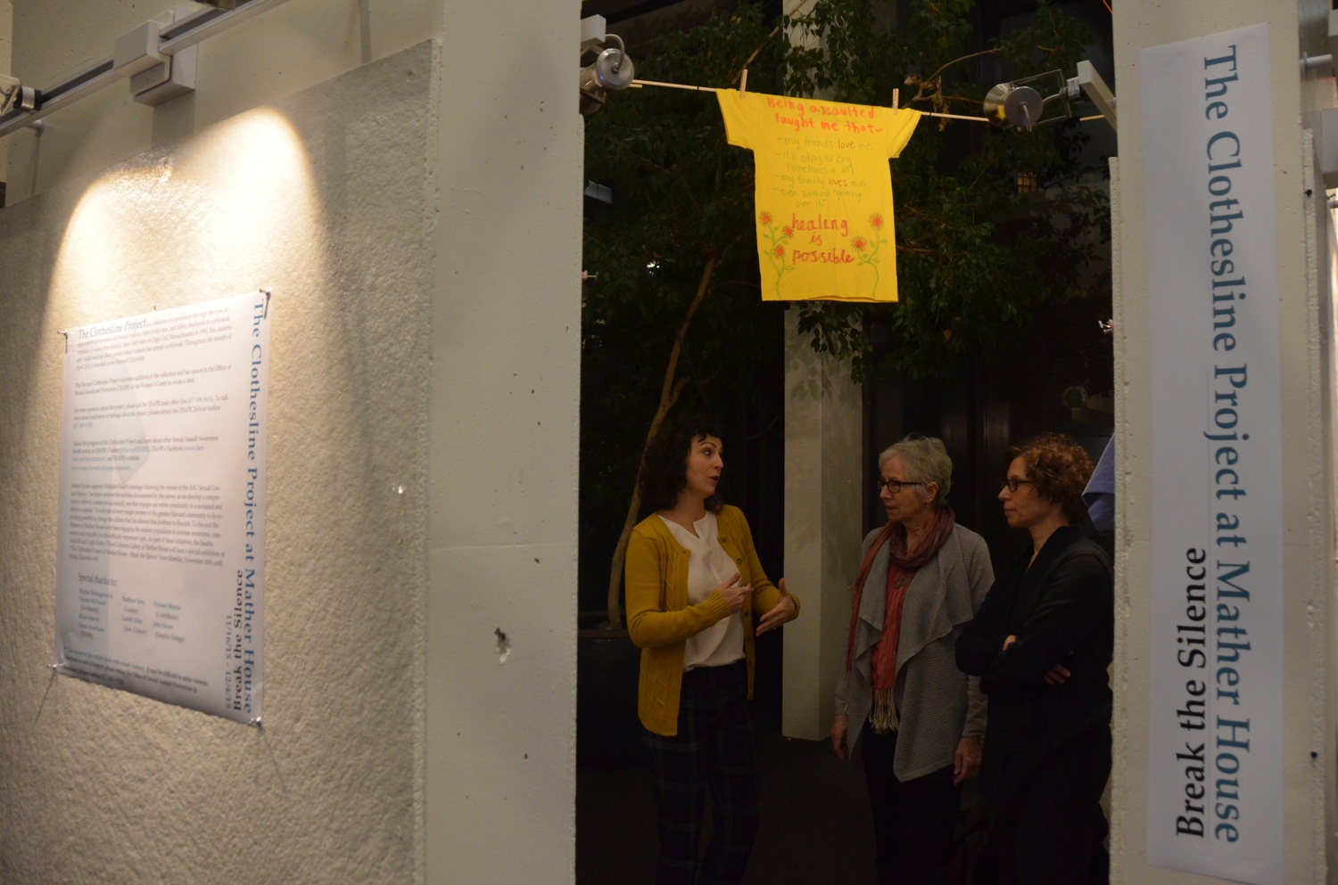 Alicia Oeser, left, former OSAPR director, discusses the Mather Clothesline Project with Christie McDonald, Mather House Co-Master, and Ann Gaylin, an associate dean of undergraduate education.