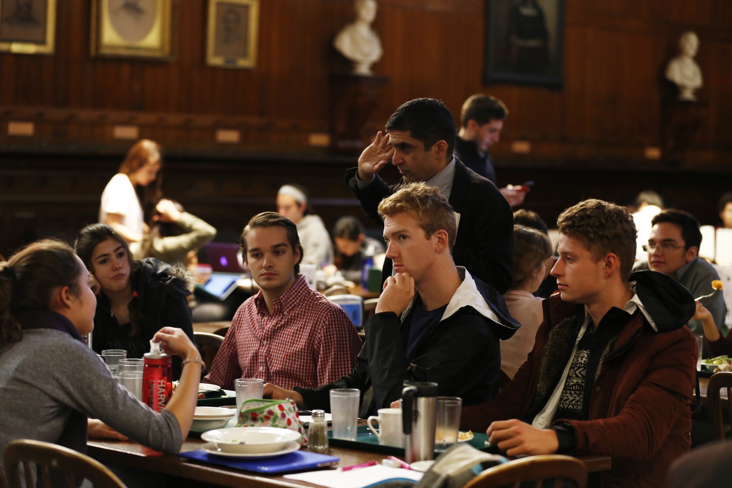 Dean of the College Rakesh Khurana speaks with first-year students in Annenberg Hall, which stayed open following reports of a bomb threat on campus.