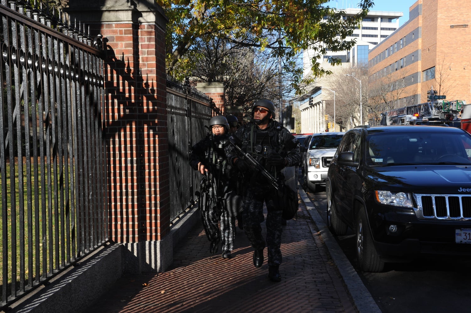 Members of the Cambridge Police Special Response Team (SRT) converge outside of Sever Hall Monday afternoon. The building was one of many evacuated during the the bomb threat.
