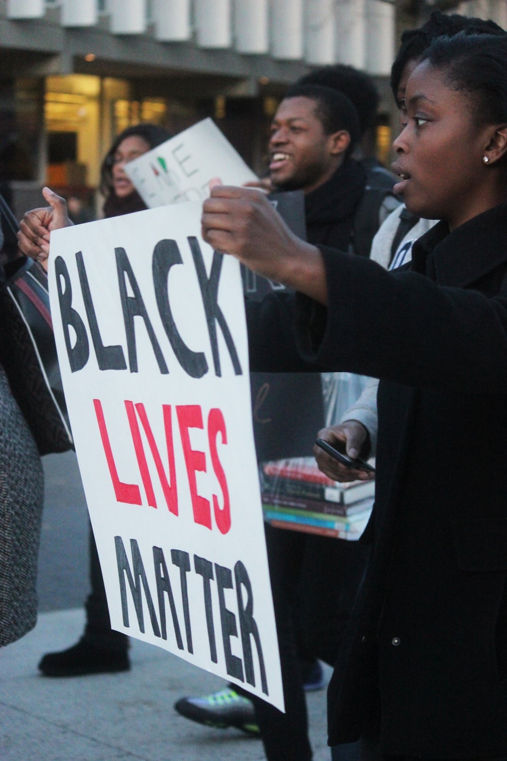 Jumai J. Yusuf '16 demonstrates with Harvard students and affiliates in the Science Center Plaza. Members of the Harvard community gathered Wednesday afternoon in an effort to stand in solidarity with those who have been affected by recent incidents of racism and discrimination on college campuses.