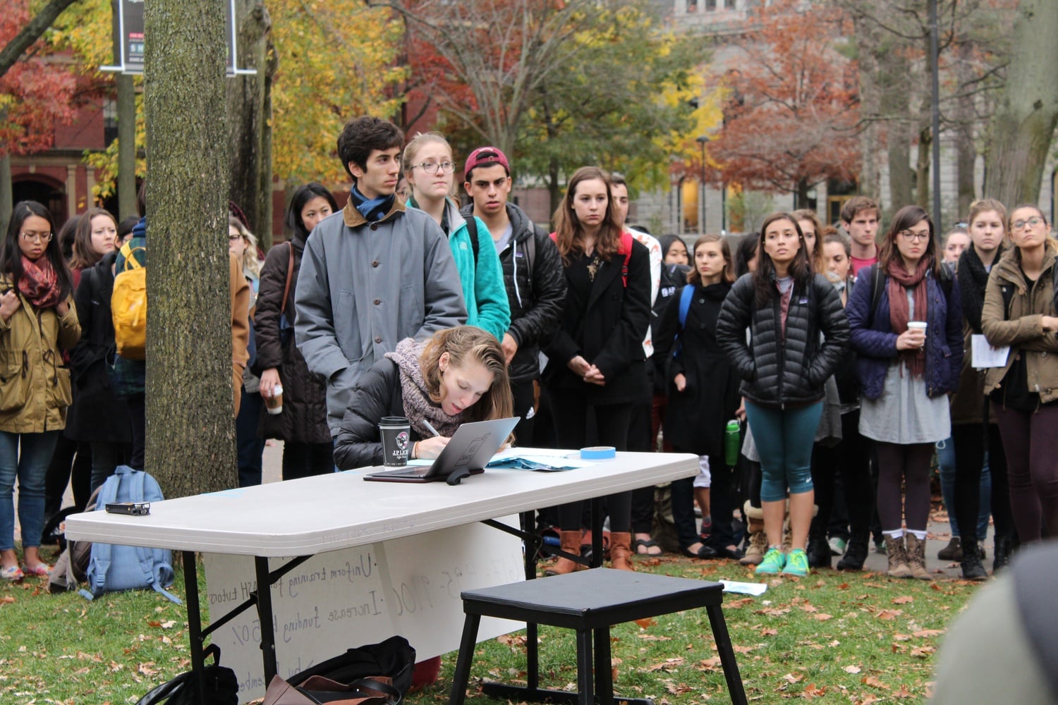 Students line up to sign a petition in support of demands to overhaul Harvard's sexual assault prevention programs at a rally in 2015.