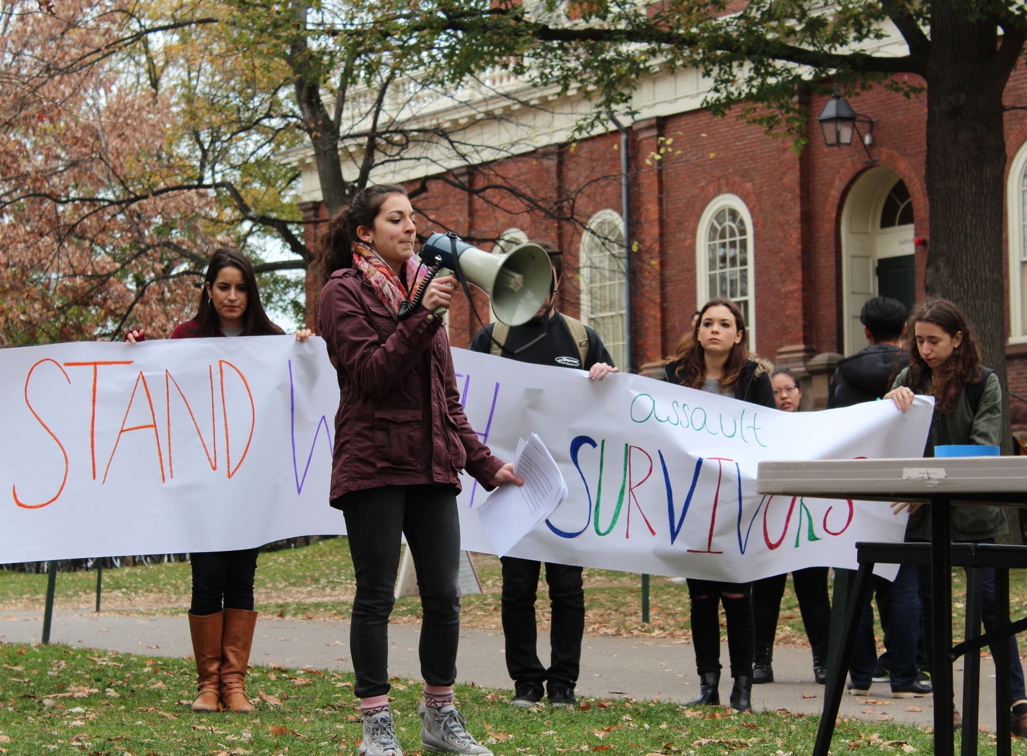 Viviana I. Maymi ‘16 speaks at a rally outside Massachusetts Hall where more than 80 undergraduates convened to call on the College to commit more resources and attention to preventing sexual assaults on campus.