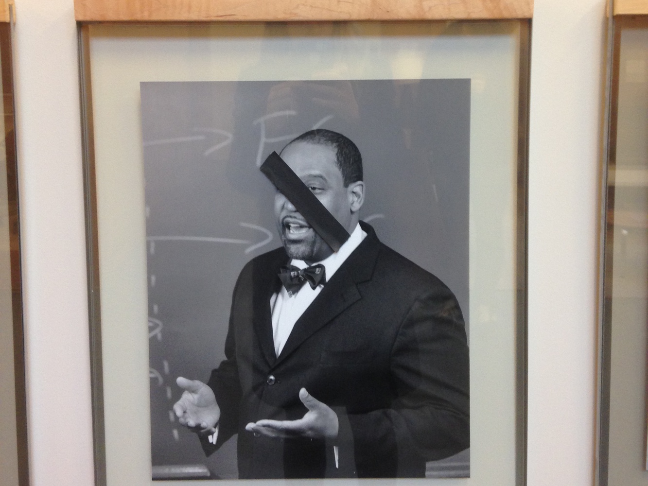 Photos of black Law School professors were covered by pieces of black tape on Thursday morning at Wasserstein Hall. 