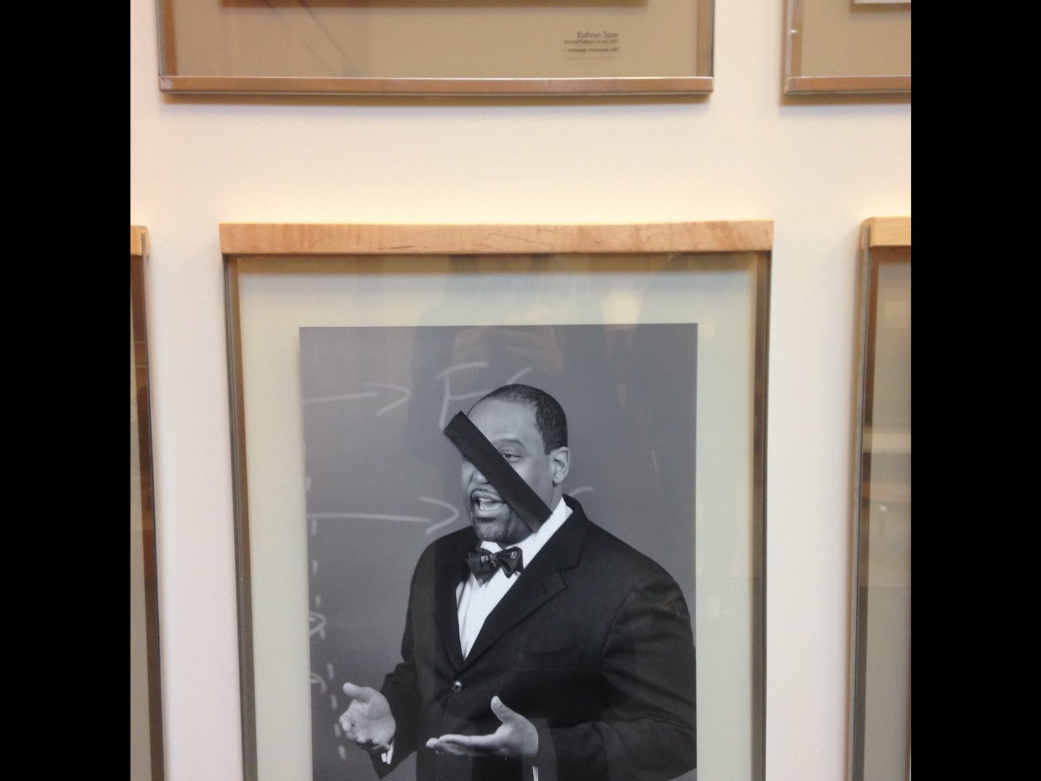 Photos of black Law School professors were covered by pieces of black tape in November.