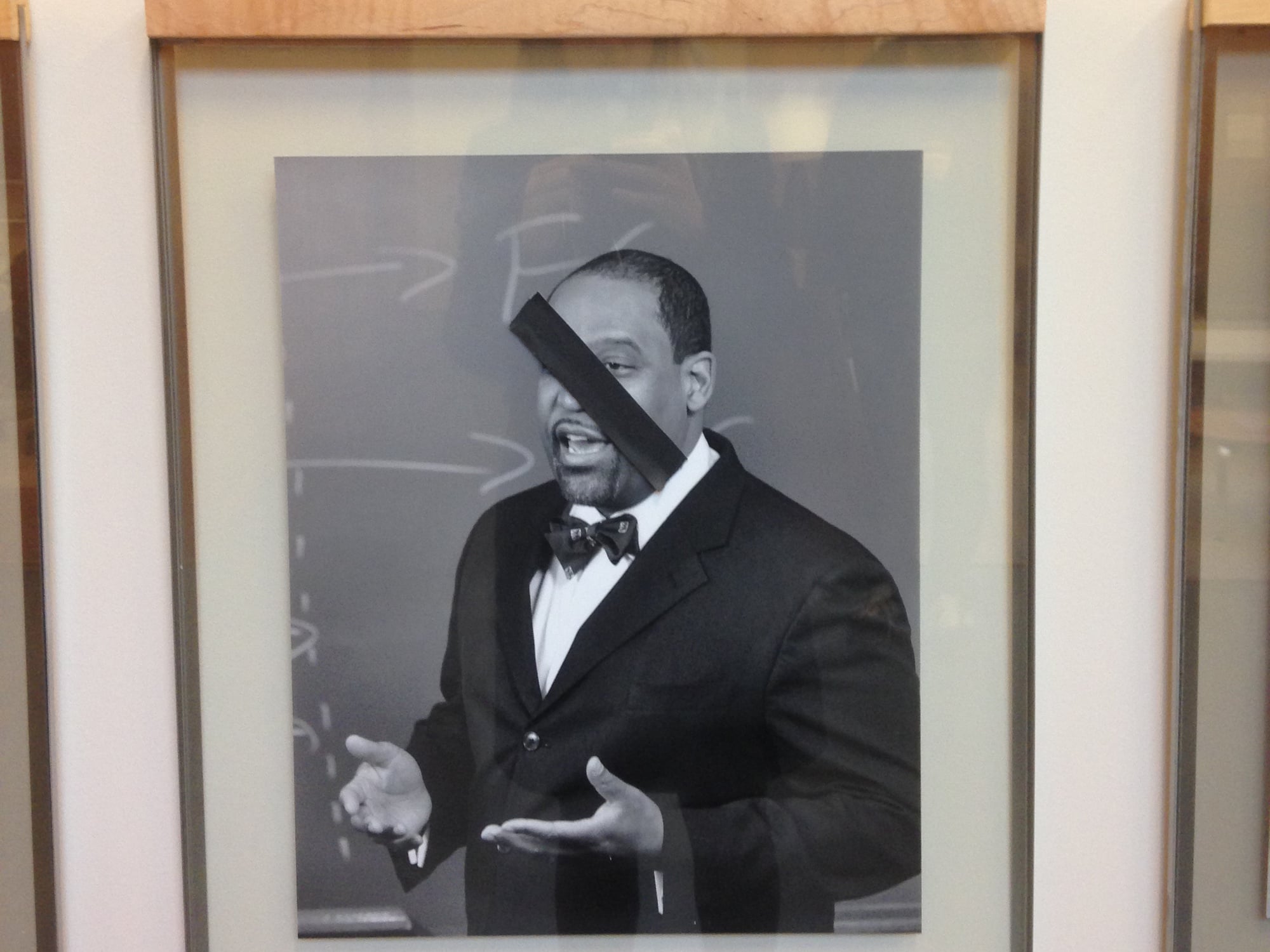 Photos of black Law School professors were covered by pieces of black tape on Thursday morning at Wasserstein Hall. 