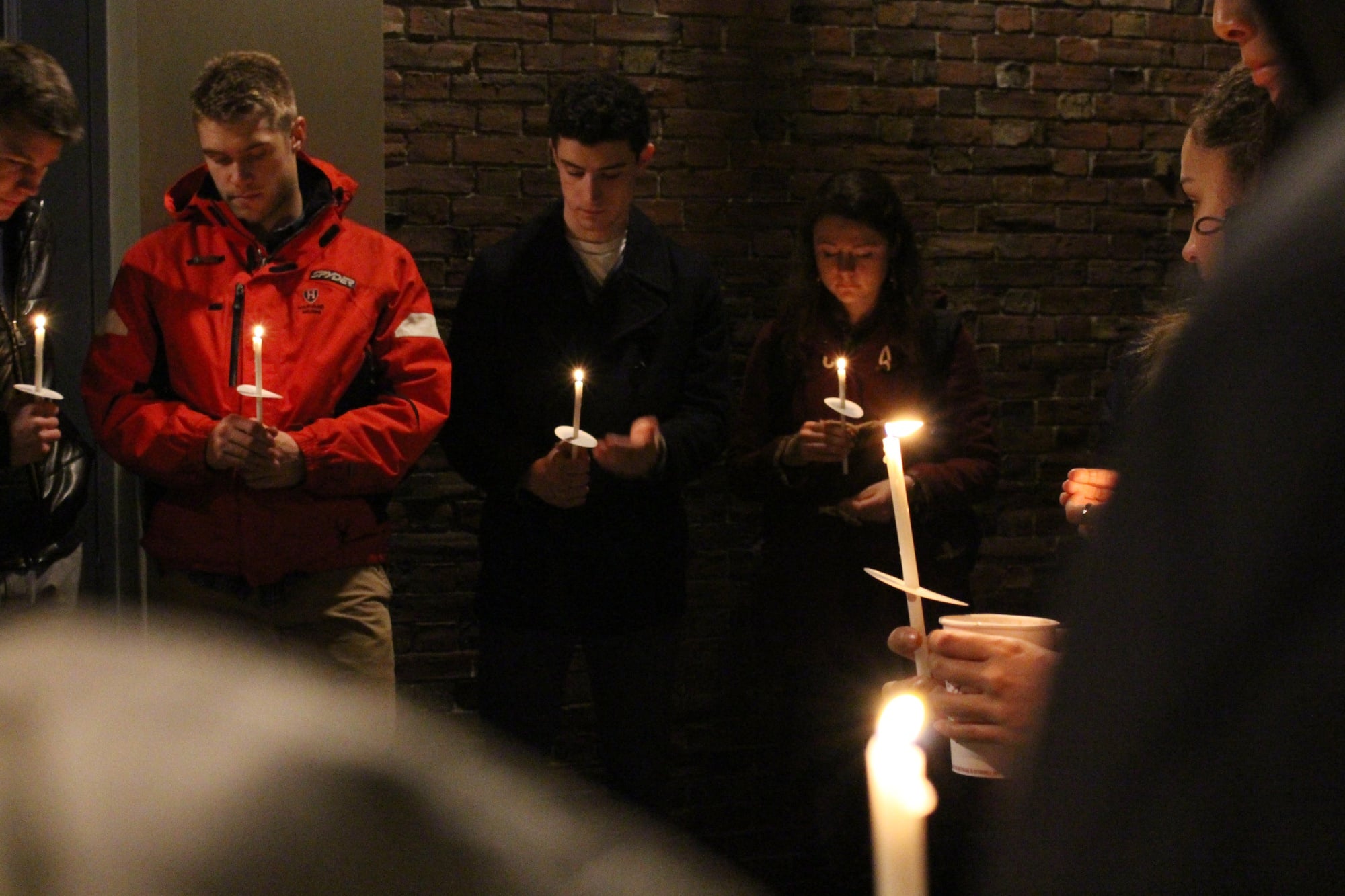 Students gather near Memorial Church for a candlelight vigil on Tuesday night to show support for those affected by the disease.