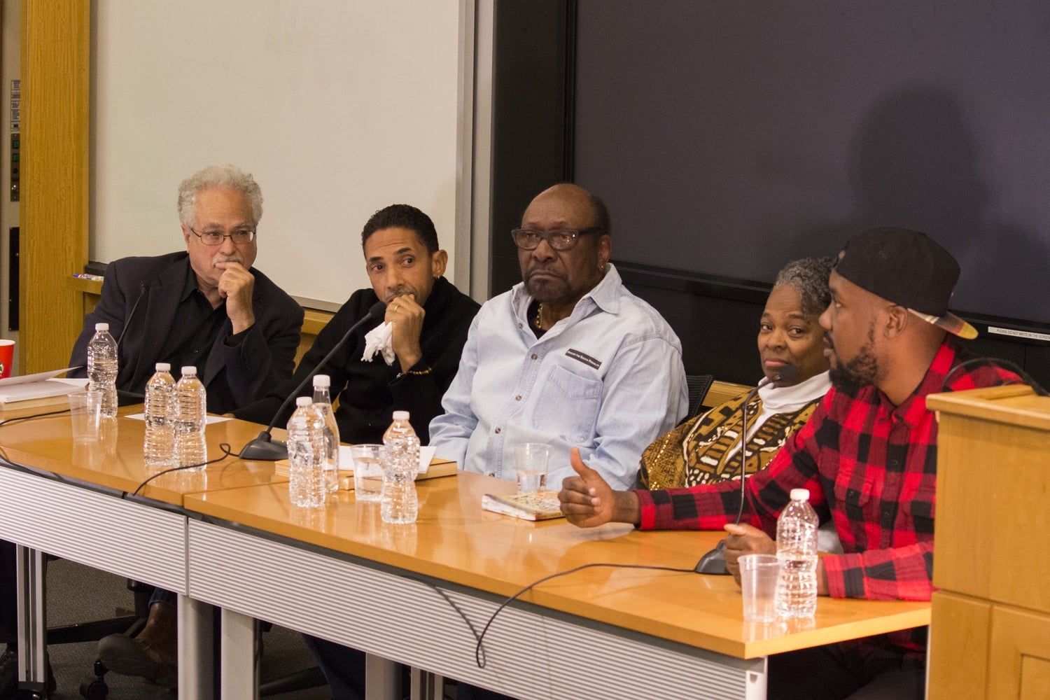 Panelists George Lipsitz, Robin D. G. Kelley, Percy Green, and Jamala Rogers listen as rapper Tef Poe speaks about his efforts to improve the lives of black people in St. Louis. On Thursday afternoon, the panelists spoke about their efforts inside and outside St. Louis and called for action against racism.