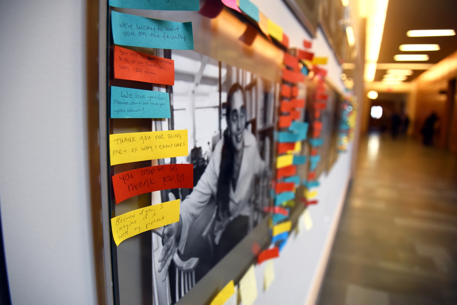 Post-it Notes with positive messages continue to border the photographs of black Harvard Law School professors after their portraits were defaced with black tape in November.

