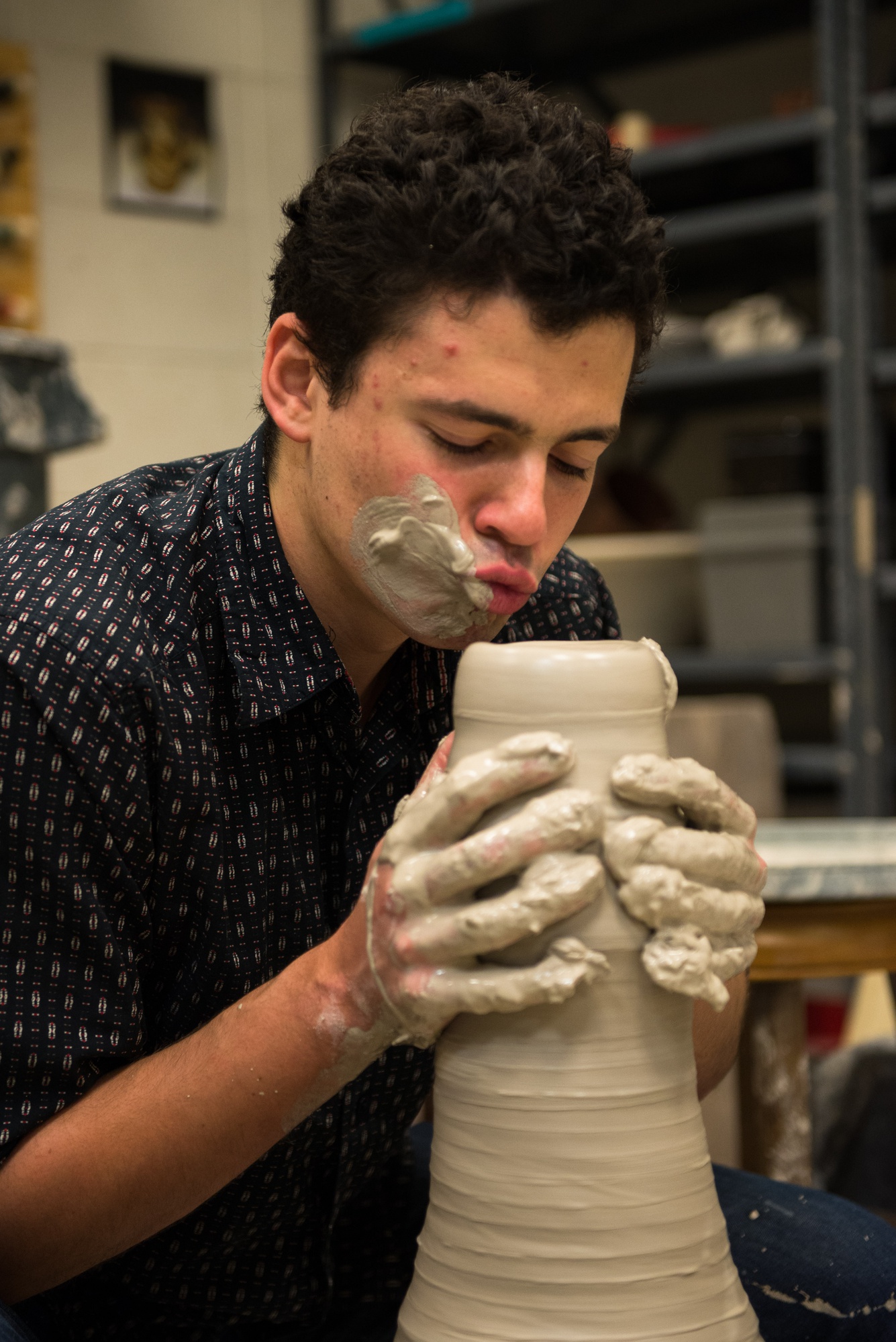 Joking around, Young shows his passion for his sculpture by giving it a smooch.