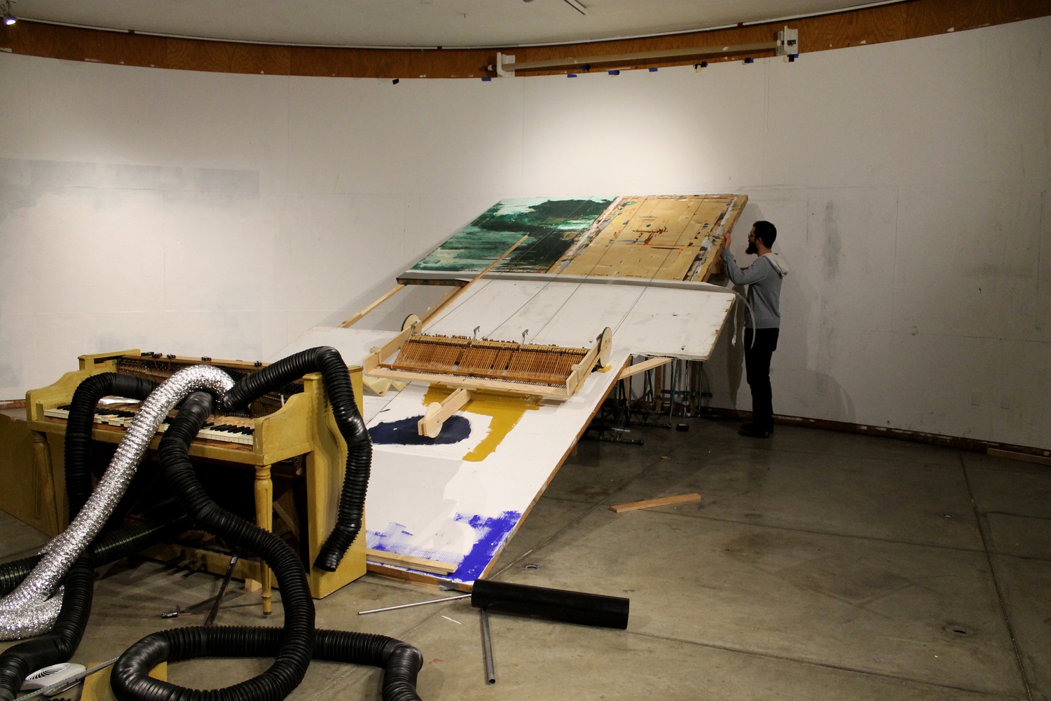 Adi Snir, a second-year graduate student in the Department of Music, cranks a lever that helps run his sculpture that is unofficially entitled “Concerto” on Tuesday night in the Carpenter Center. Snir presented his sculpture as part of the Fall Open Studios that were held by the Department of Visual and Environmental Studies.