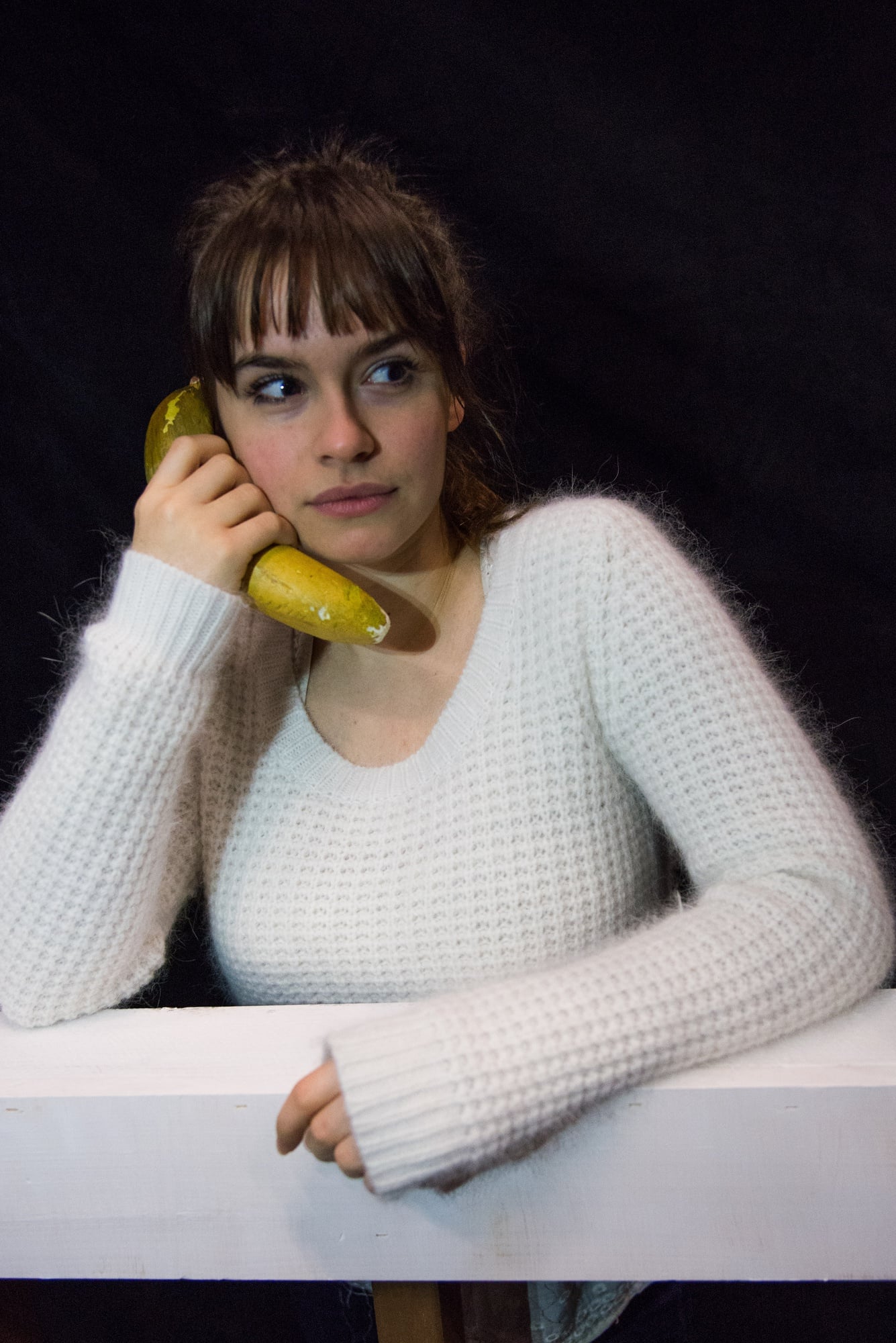 Horvath goofs around, posing with a prop banana she found on set. 