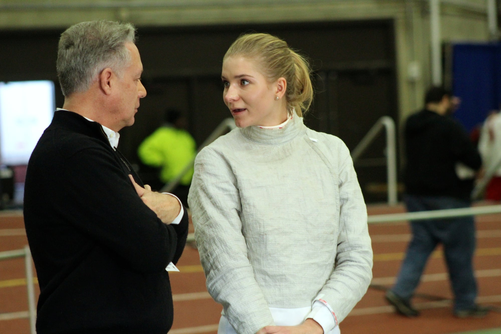 Junior saber fencer Adrienne Jarocki chats with Harvard coach Peter Brand in between bouts at the FIE Sabre Grand Prix. Jarocki claimed her second NCAA title in her collegiate career.