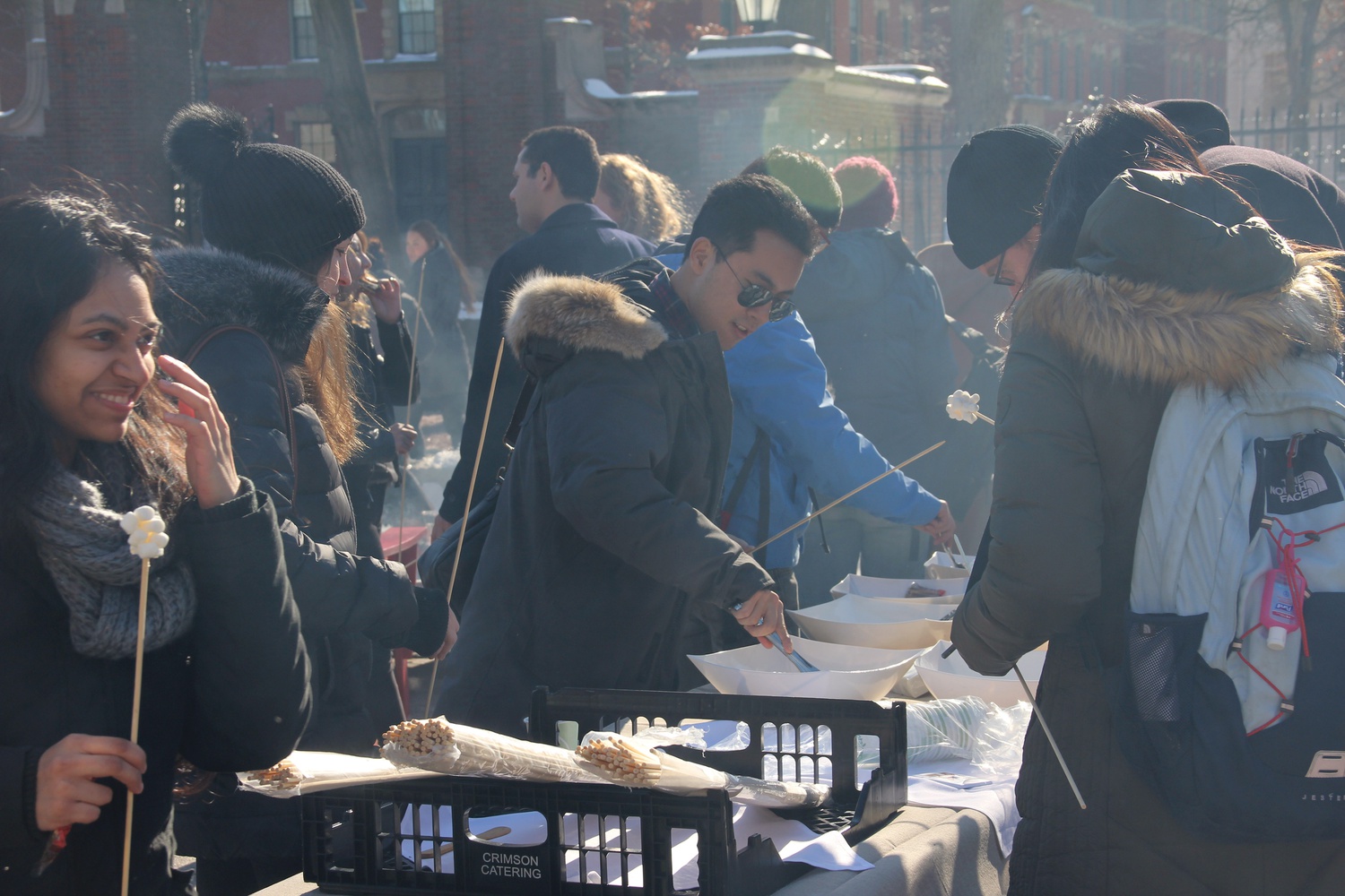 Students and other passersby gather at the kickoff of the Science Center plaza skating rink. The event featured student figure skaters as well as free s'mores and hot chocolate.