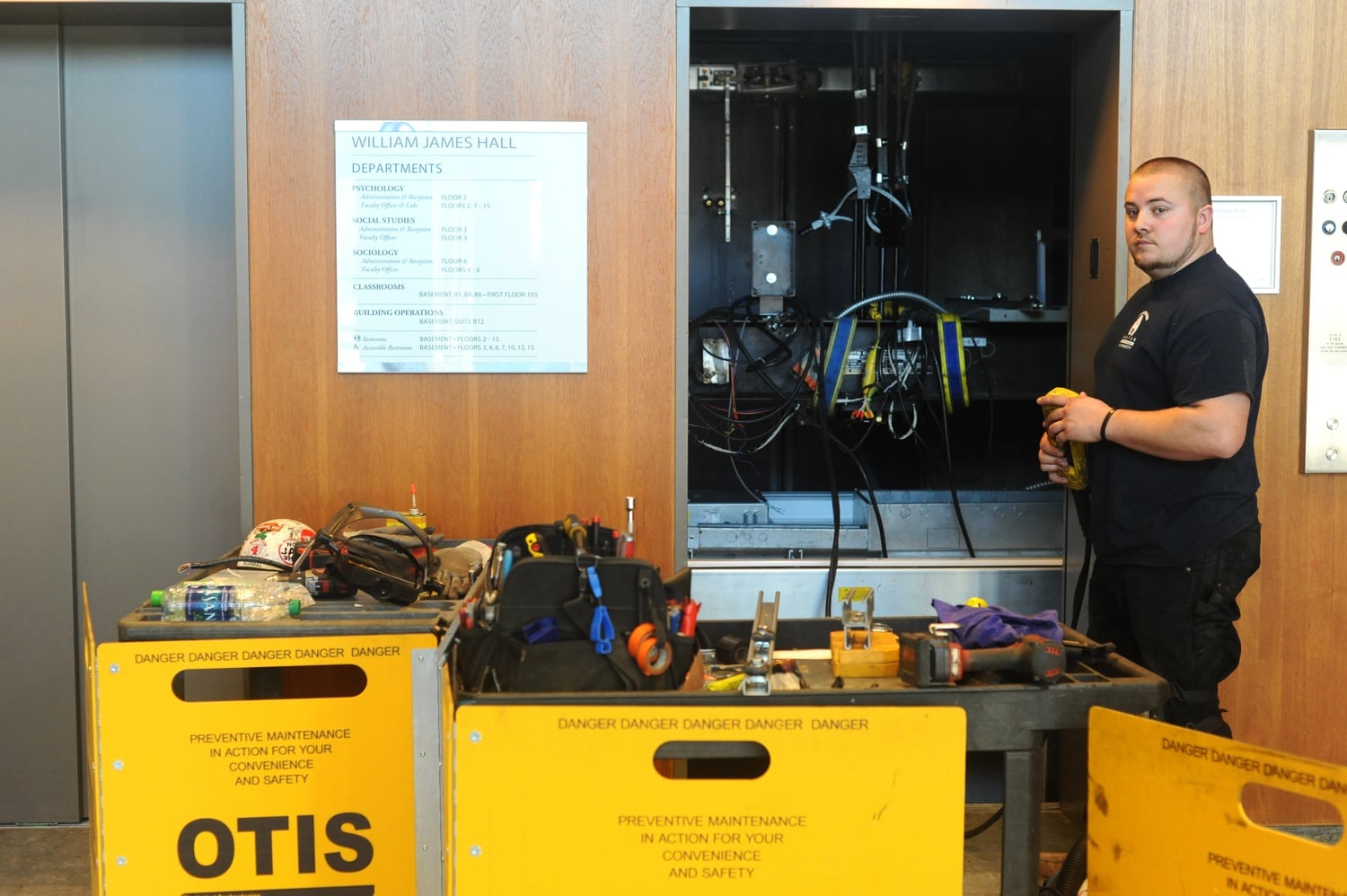 Chris Weenen performs maintenance on an elevator in William James Hall Monday afternoon.