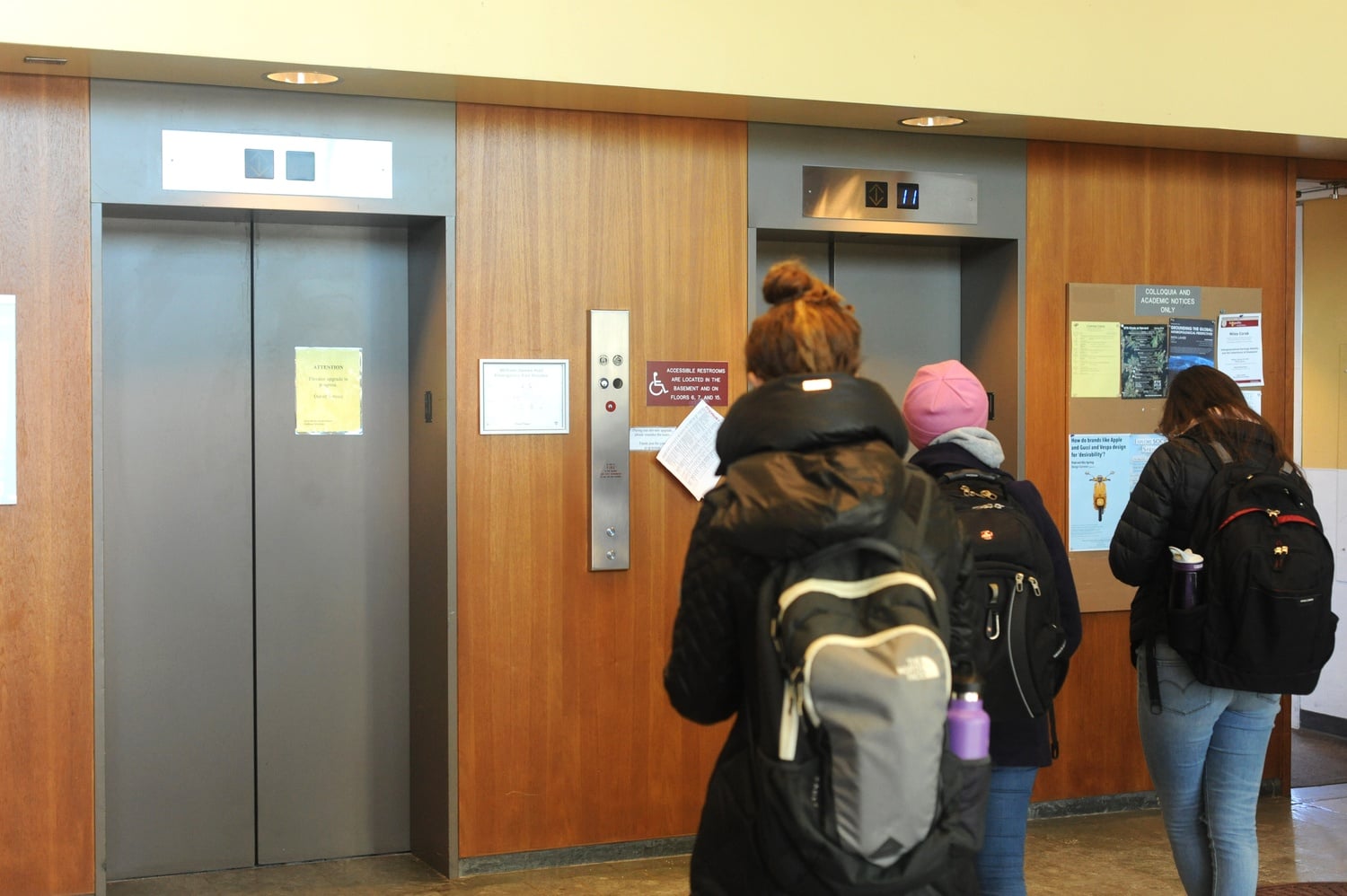 Students wait for one of the two working elevators in Harvard’s William James Hall to arrive on the first floor Monday afternoon. The building’s three elevators are undergoing repairs one at a time. 