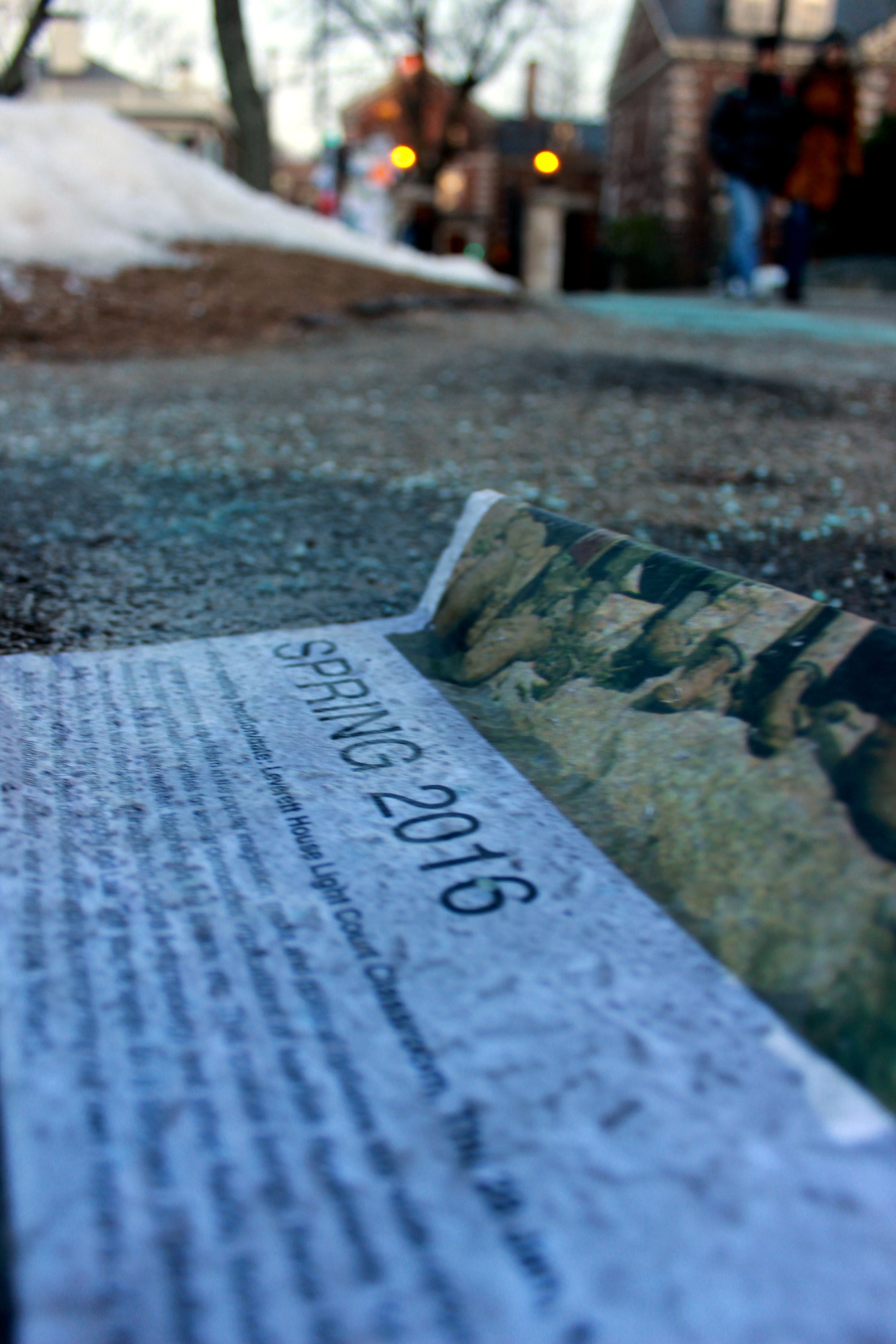 A comp poster rests on the ground by the Lamont poster kiosk. Student group members wake up early to advertise their clubs during specified times on Mondays and Thursdays.