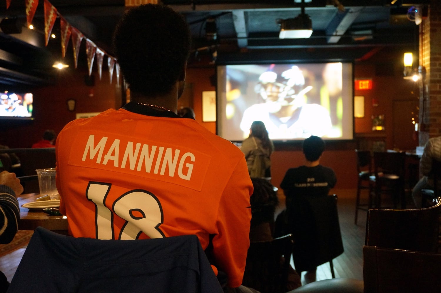 Students watch as the Denver Broncos defeat the Carolina Panthers with a final score of 24-10 during the Super Bowl on Sunday night. This watch party in Cambridge Queen’s Head was one of many on campus.
